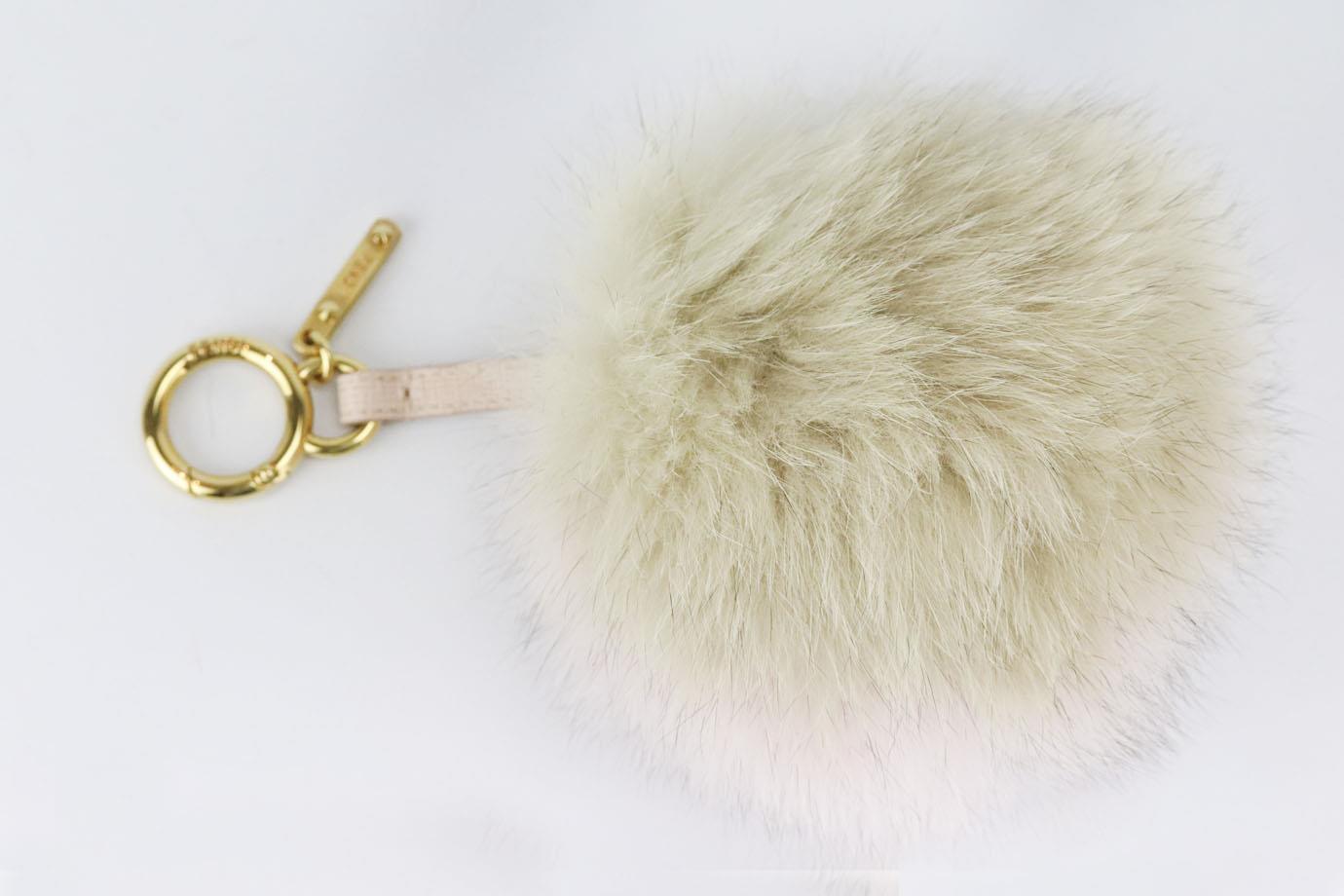 Fendi fox fur and leather bag charm. Yellow. Lobster clasp fastening at top. Does not come with dustbag or box. Height: 7 in. Width: 5 in
