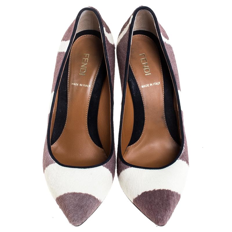 Add a subtle touch of magic to your look by donning these pony hair and suede trim pumps. These pumps from Fendi showcase a comfortable and stylish look you simply cannot miss. The plush design of these classic pumps is finished with a set of