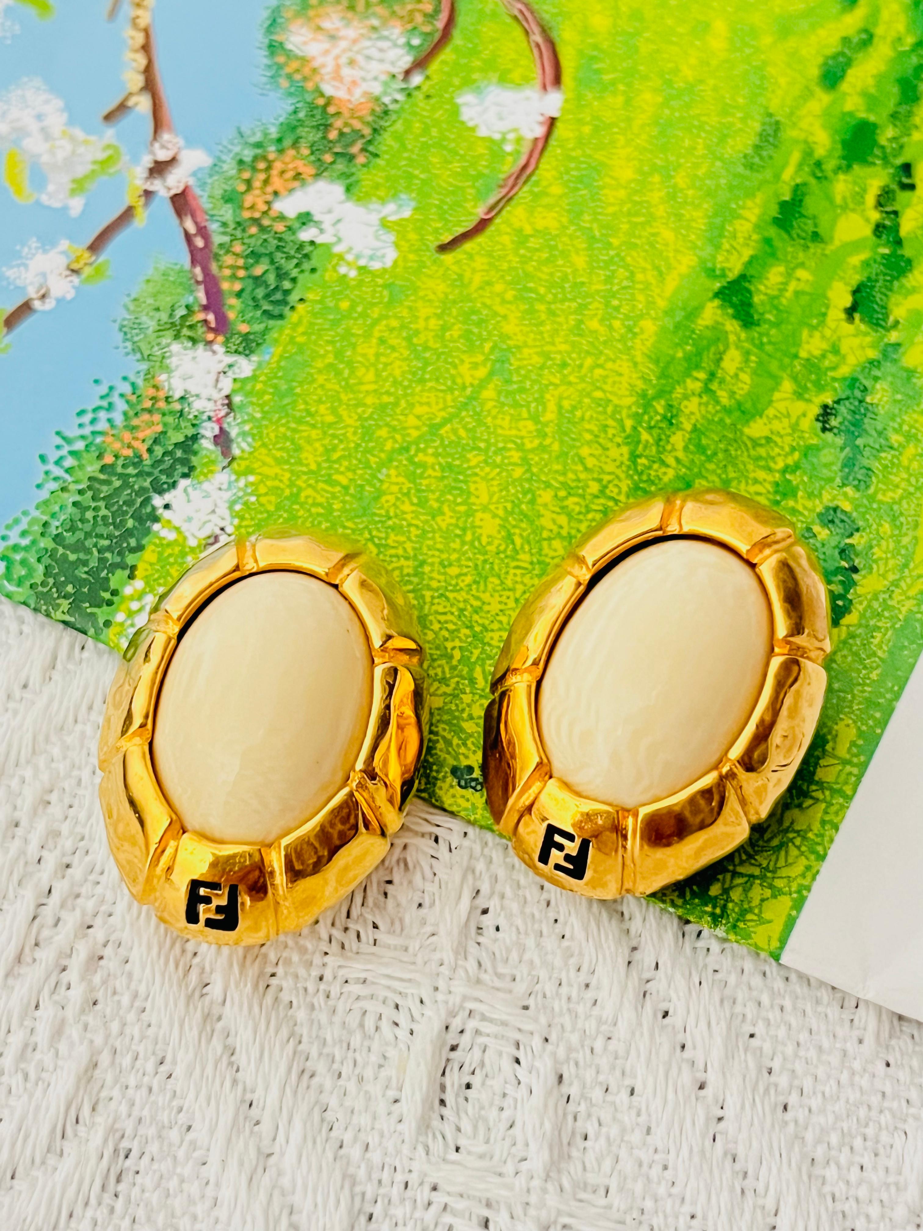 Fendi Vintage 1980s Unisex Large Asymmetric Fendista Logo FF Ivory Oval Chunky Statemet Cabochon Modernist Clip Earrings, Gold Plated 

Very good condition. Maybe light scratches or colour loss, barely noticeable. 100% Genuine.

Unique design. Logos