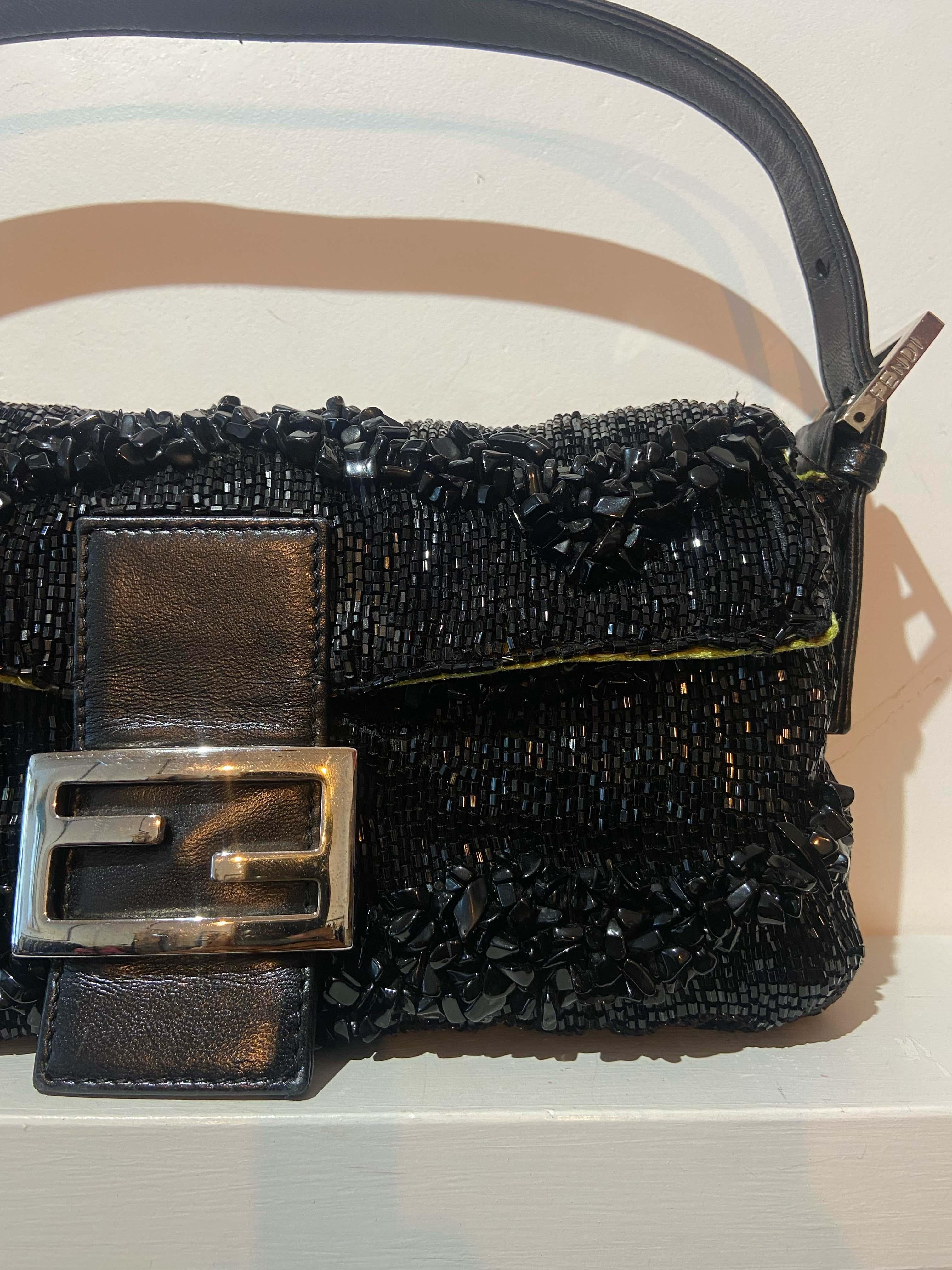 Fendi vintage 1990's beaded baguette bag. Features all over beads, adjustable strap length, magnetic popper closure, yellow/green lime satin lining and interior zipped pocket. In excellent vintage condition.

Brand: Fendi
Color: Black
1990
Baguette