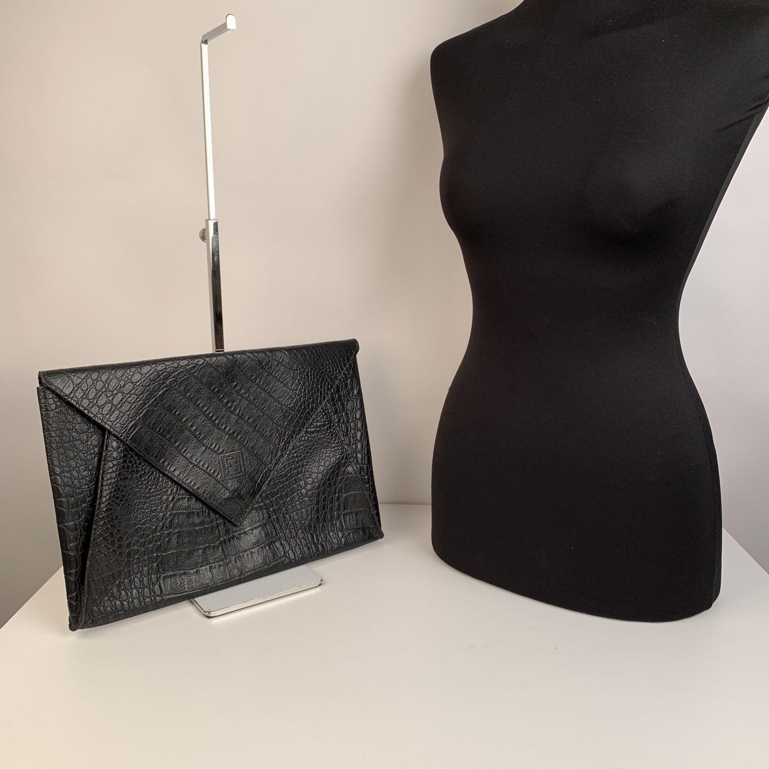 Vintage FENDI Porfolio/clutch bag from the 80s. Crafted in black leather with embossd crocodile look. Flap with magnetic button closure. FF - Fendi logo on the front, Signature fabric lining. 1 side zip pocket inside. 'Fendi s.a.s. Roma - Made in