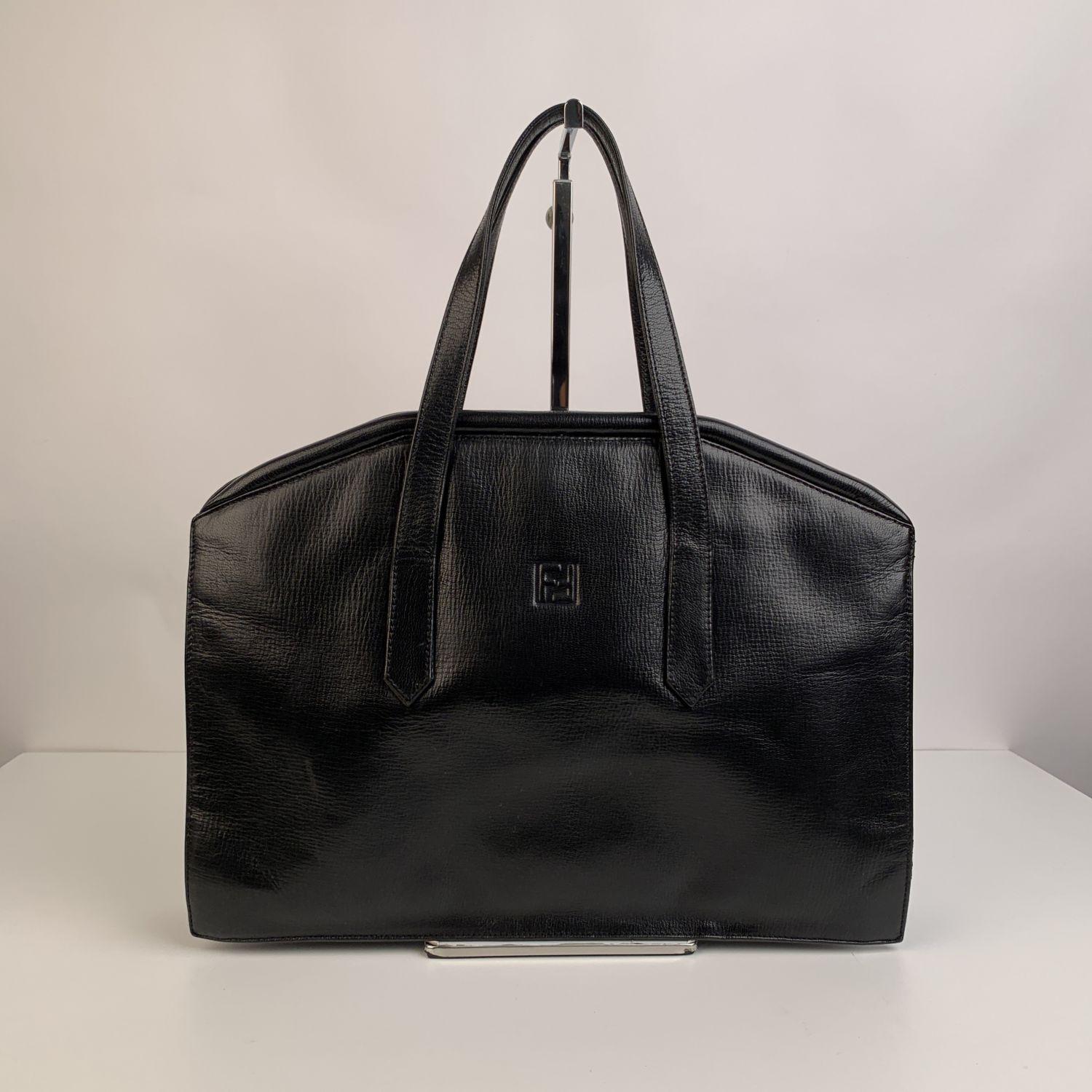 Vintage satchel bag by FENDI, crafted in black leather. Framed top with kiss lock closure. 1 open section on the front and 1 open section on the back. 1 side zip pocket inside. FF - Fendi logo on the front, 'Fendi s.a.s. Roma - Made in Italy' tag