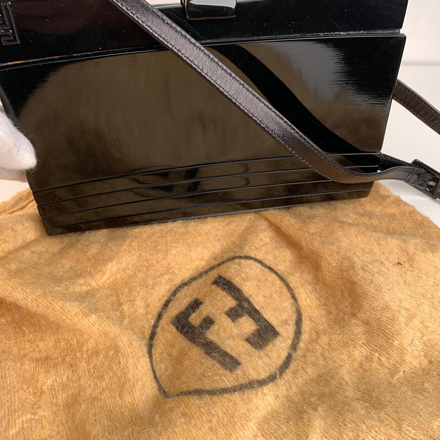 Beautiful and rare vintage Fendi convertible bag from the 60s/70s. The bag is crafted in balck lucite and leather. Clasp closure on top. FF - FENDI logo on the front. Removable leather shoulder strap (can be use as a shoulder bag or as a clutch