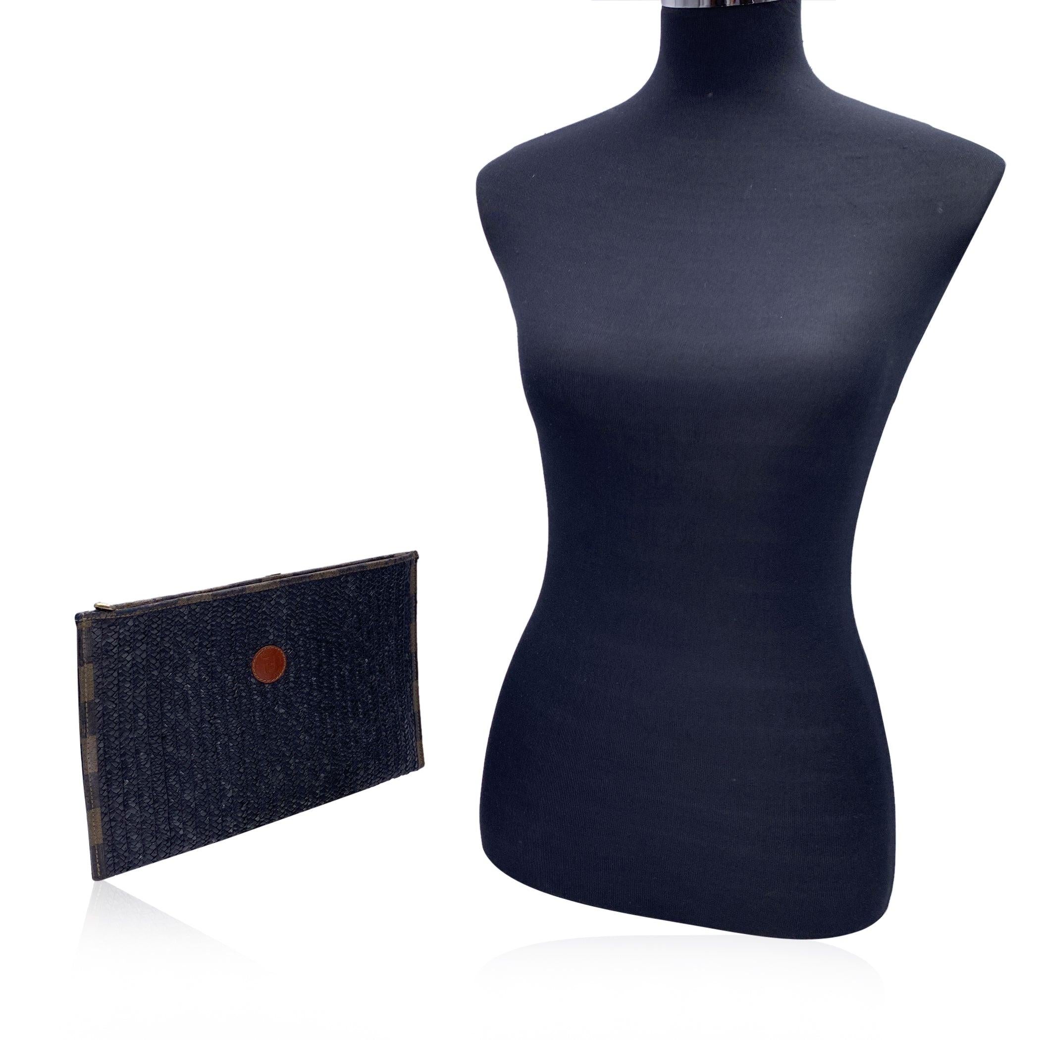 Vintage Fendi black woven raffia clutch bag. Pequin striped canvas trim. FF -FENDI leather patch on the front. Upper zipper closure. Pequin striped canvas lining. 'Fendi s.a.s. Roma - made in Italy' tag inside Condition B - VERY GOOD Gently used.