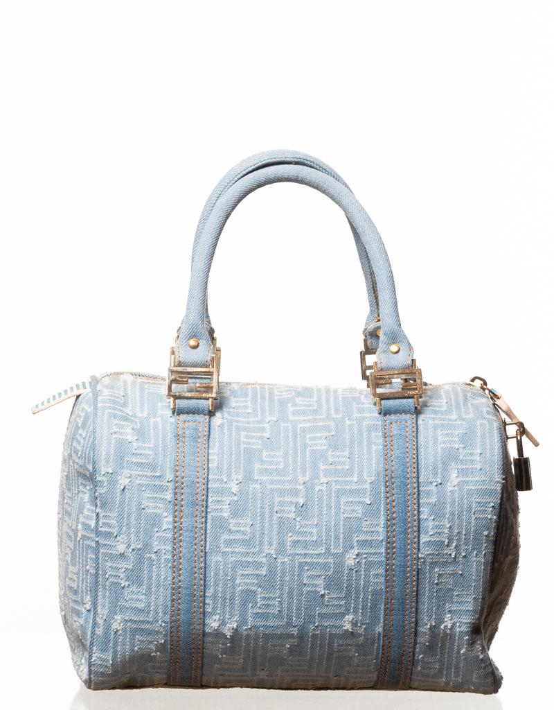 This Fendi bauletto Boston 25cm handbag is made with distressed blue denim with white stitched Fendi Zucca monogram pattern. Featuring gold-tone hardware, dual rolled top handles, logo buckle accents, cerulean and creme striped leather finishes,