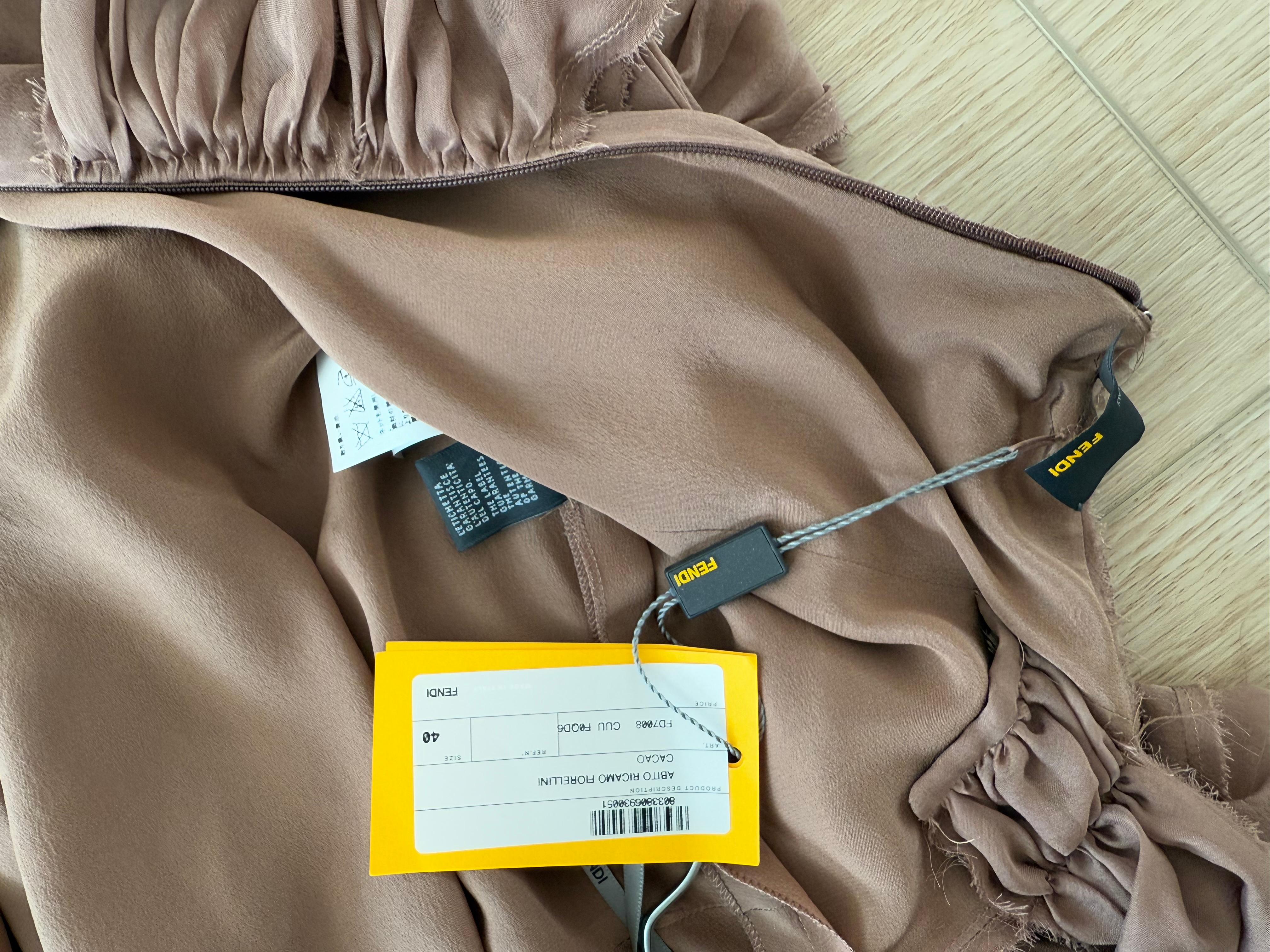 Fendi
Vintage
100% silk
Leans more toward neutral warm toned brown
Pink floral rosettes with micro sequins and beads
Very lightweight
Flattering knotted front, ruching, and halter neckline
Has a distressed raw edging
My mannequin does not fill this