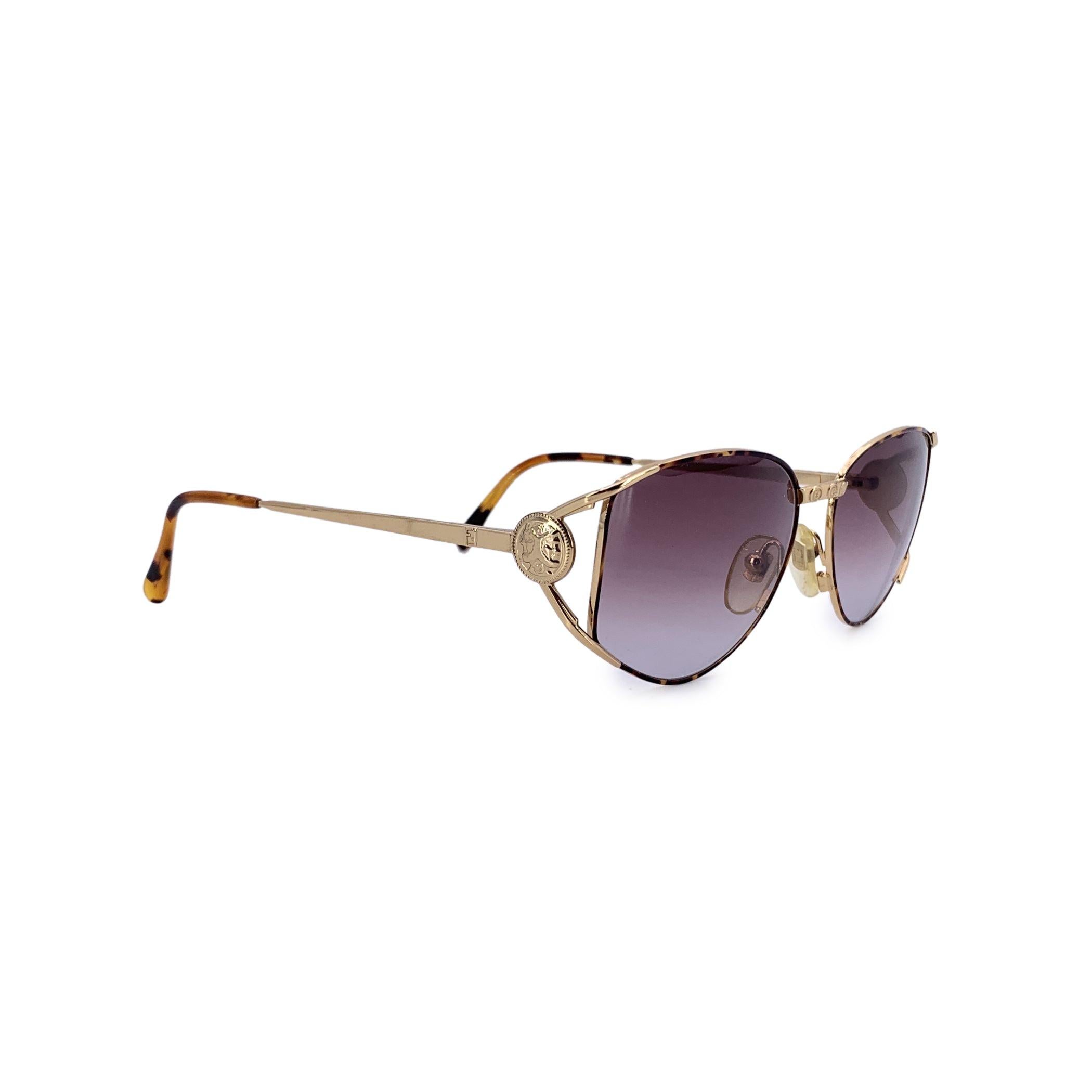 A striking blend of heritage and high fashion, these Fendi FV 239 sunglasses in color 226 are a rare vintage gem that captures the brand's bold identity with refined precision. The design centers around a gold metal frame, elegantly accented with a