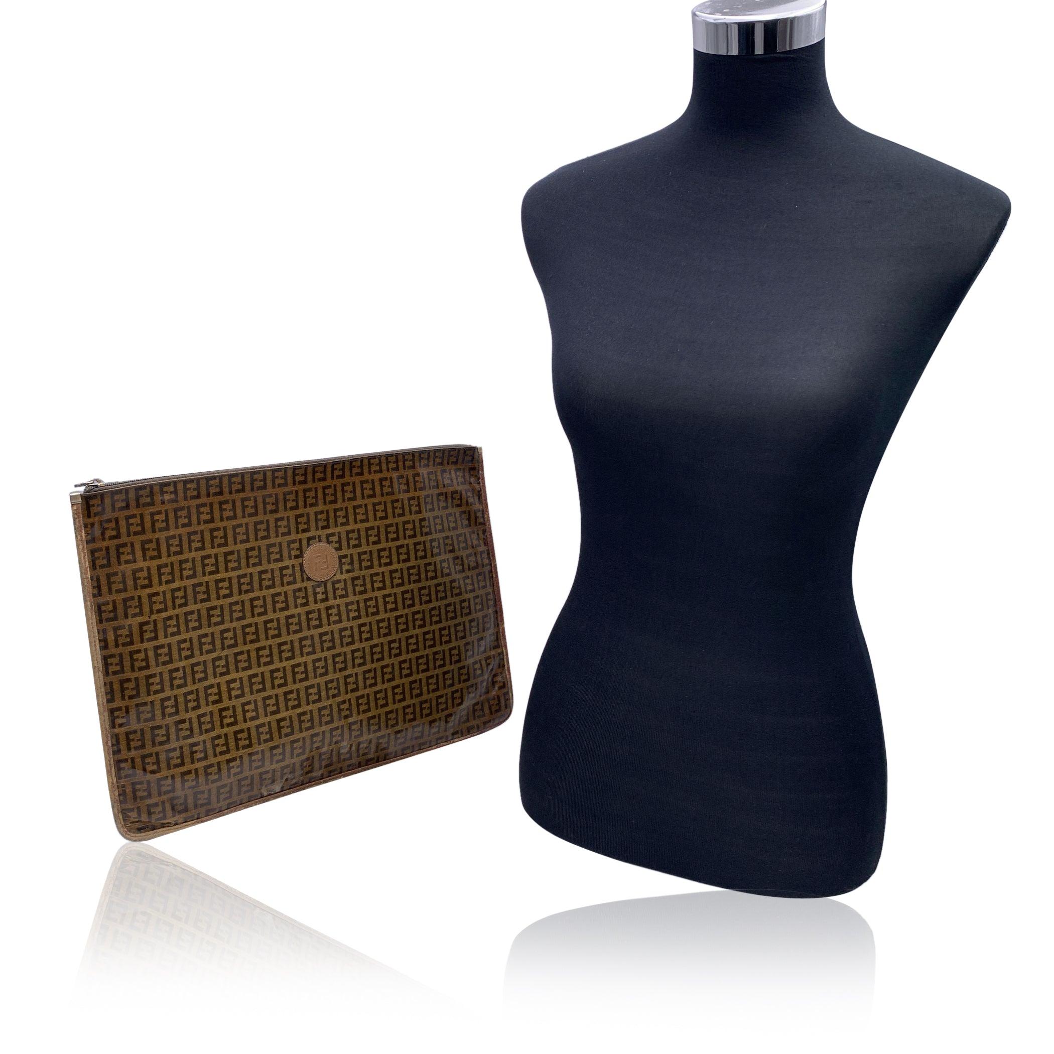 This beautiful Bag will come with a Certificate of Authenticity provided by Entrupy. The certificate will be provided at no further cost. Vintage FENDI Porfolio/clutch bag from the 80s. Crafted in beige and brown vinyl canvas with brown leather