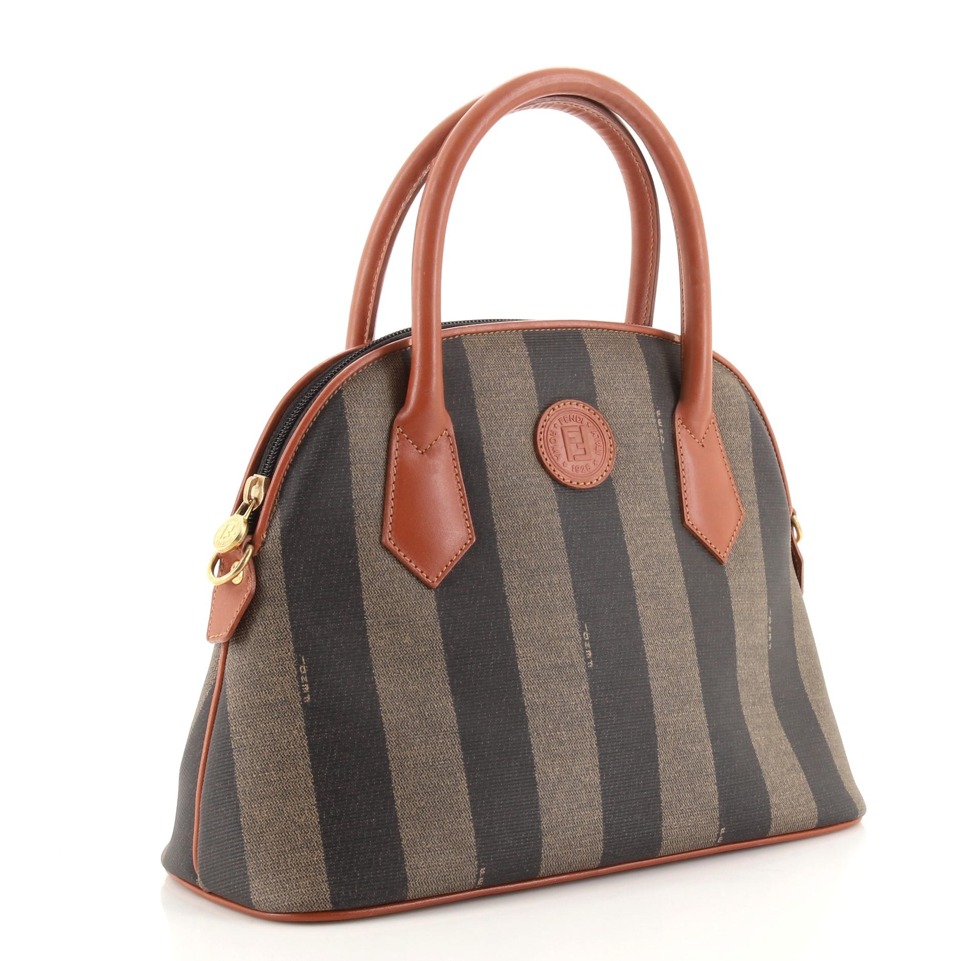 Condition: Good. Odor in interior. Creasing, light wear and marks on exterior, wear and scuffs on leather trims, strap and in interior, indentations on base. Moderate wear, darkening and marks on handles, peeling on handle wax edges. Splitting and