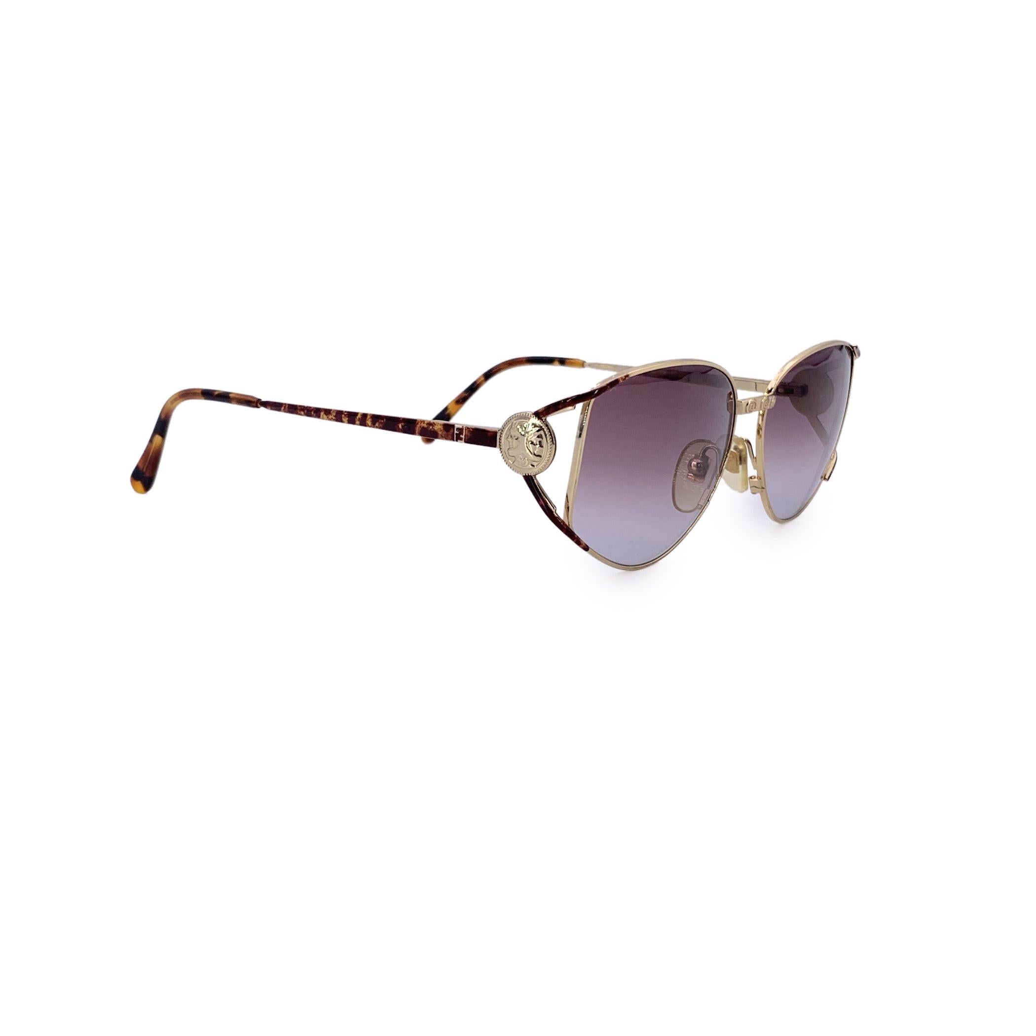 A striking blend of heritage and high fashion, these Fendi FV 239 sunglasses in color 521 are a rare vintage gem that captures the brand's bold identity with refined precision. The design centers around a gold metal frame, elegantly accented with a
