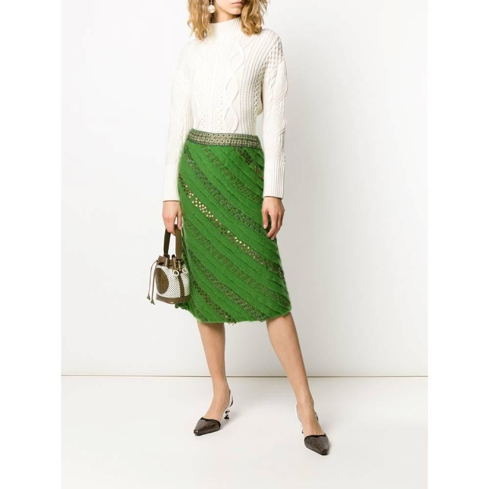 Fendi green wool straight over-the-knee length 90s skirt with diagonal pleats embellished with metallic ornaments. Waist beige cotton detail with metallic eyelets and green sequins. Side zip closure.

Size: 42 IT

Flat measurements
Height: 72