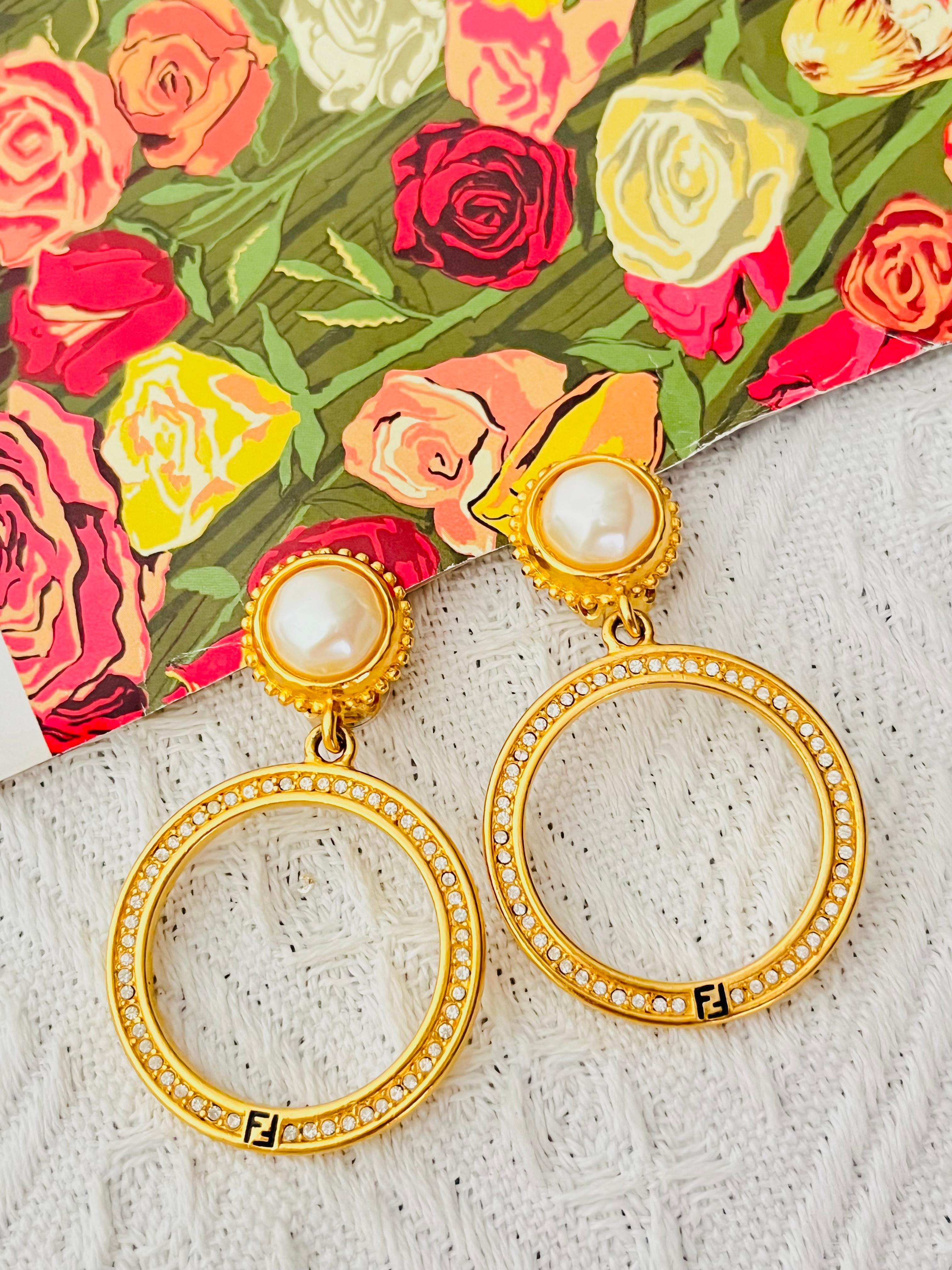 Fendi Vintage Large Logo F Fendista Circle Round Hoop White Round Pearl Crystals Drop Dangle Modernist Elegeant Clip Earrings, Gold Plated

Very excellent condition. Looks very new. 100% genuine. Unique design.

A very beautiful pair of clip on