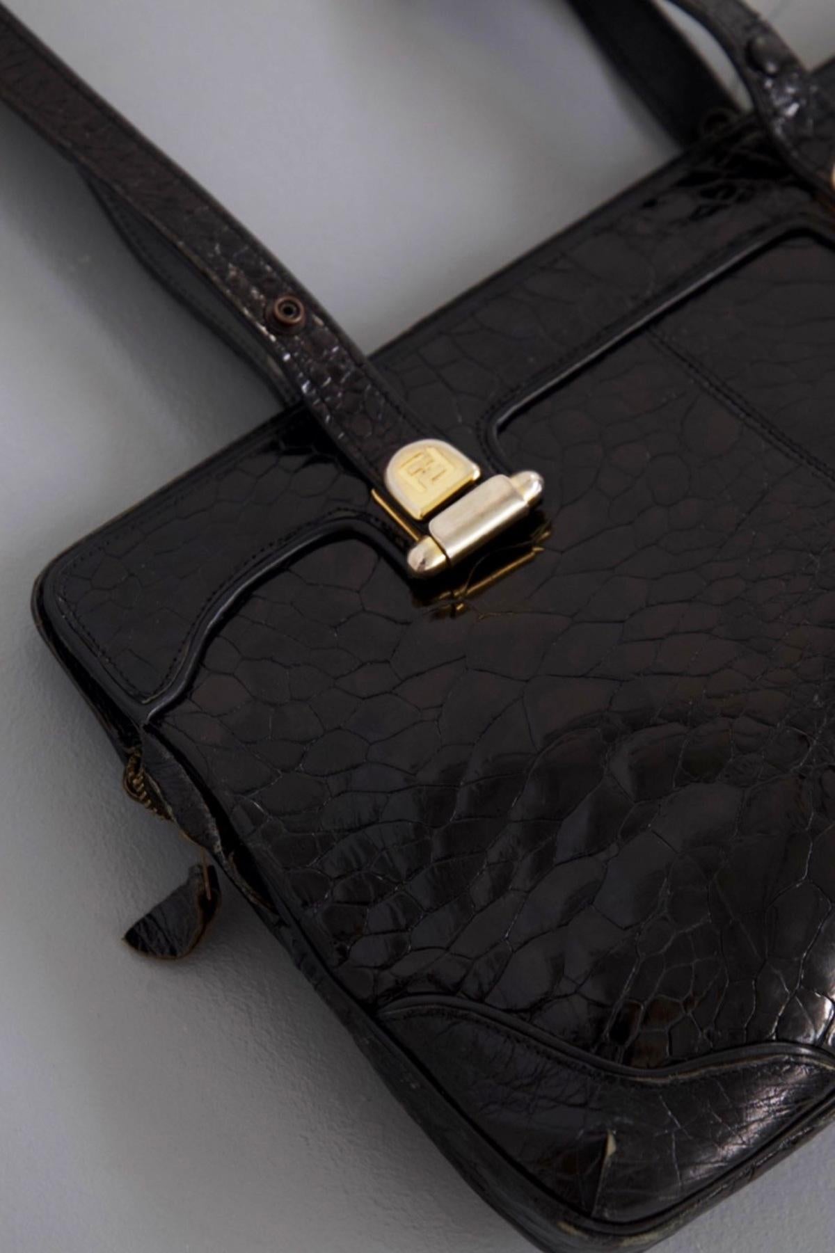 Beautiful vintage bag designed by the great designer Fendi in the 1980s, made in France.
The bag has rectangular shape, leather, with a crocodile texture, black color.
The bag is signature with the classic inverted double F, with double straps,