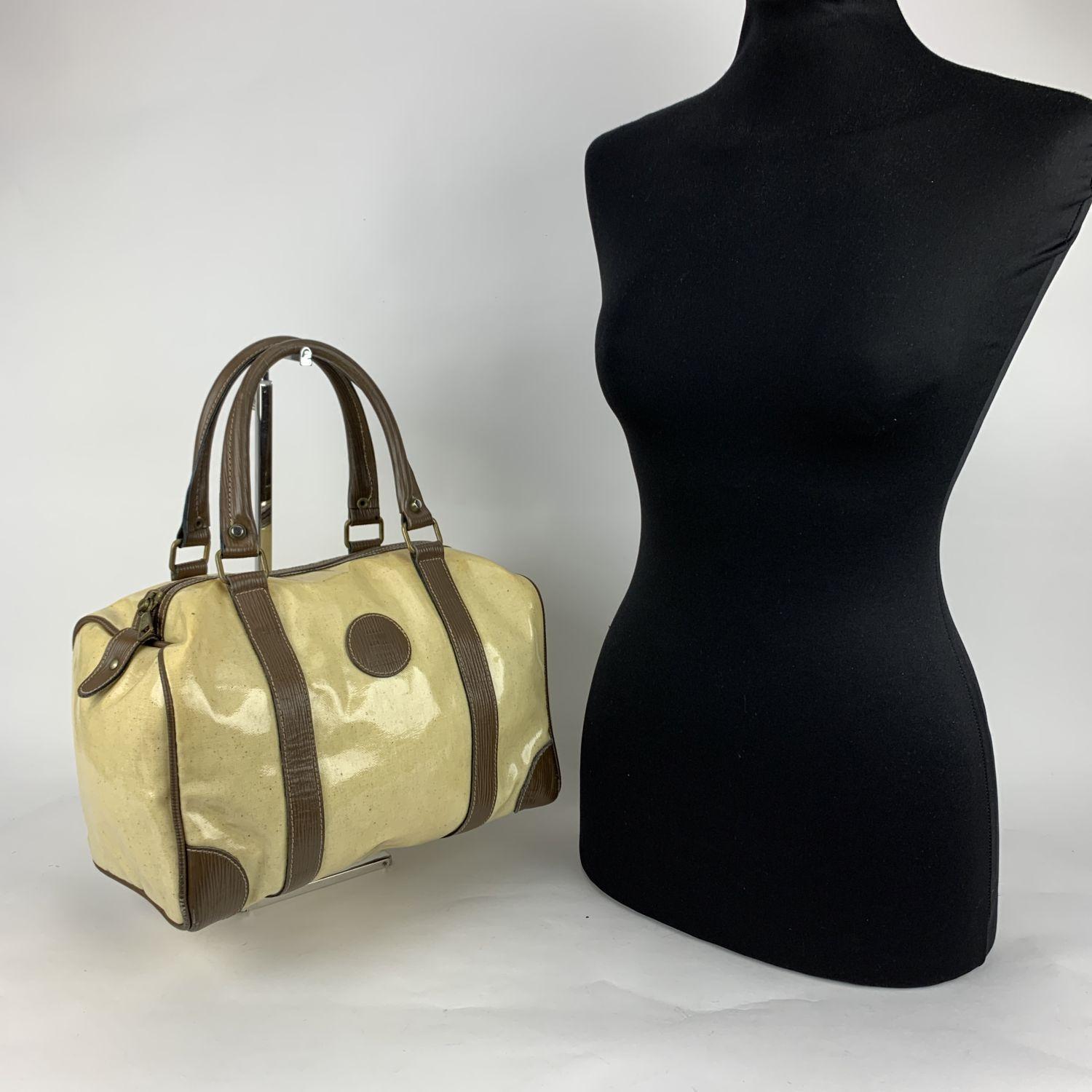 Vintage Fendi Boston bag made in yellow vinyl canvas with brown leather trim and handles. FF - FENDI logo patch on the front. Upper zipper closure. 'FENDI Roma - Made in Italy' tag inside. Details MATERIAL: Vinyl COLOR: Yellow MODEL: - GENDER: Women