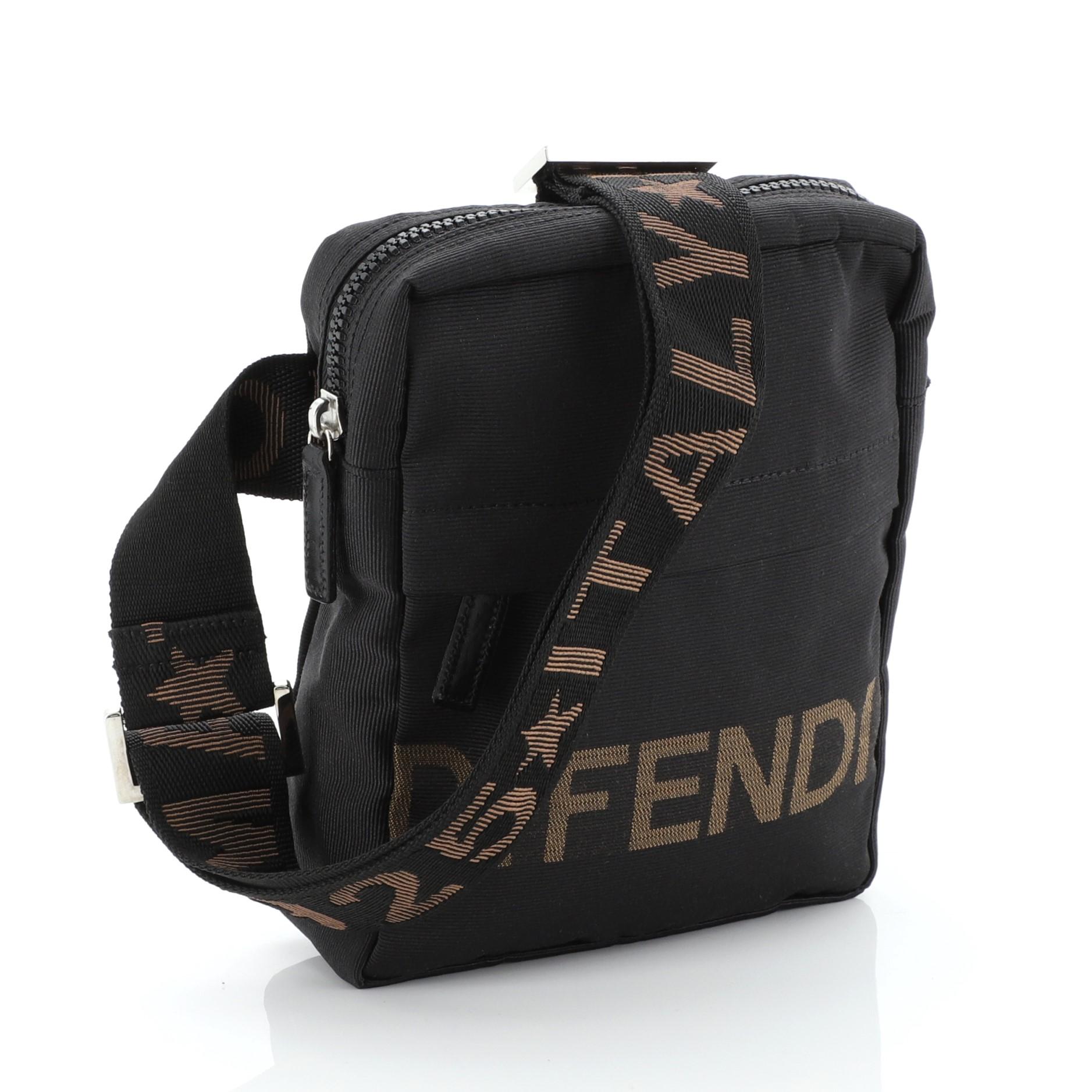 This Fendi Vintage Logo Messenger Bag Nylon Small, crafted from black zucca canvas, features the iconic Vintage Fendi logo front zip pocket, and silver-tone hardware. Its flap opens to a black fabric interior.

Condition: Excellent. Minimal wear in