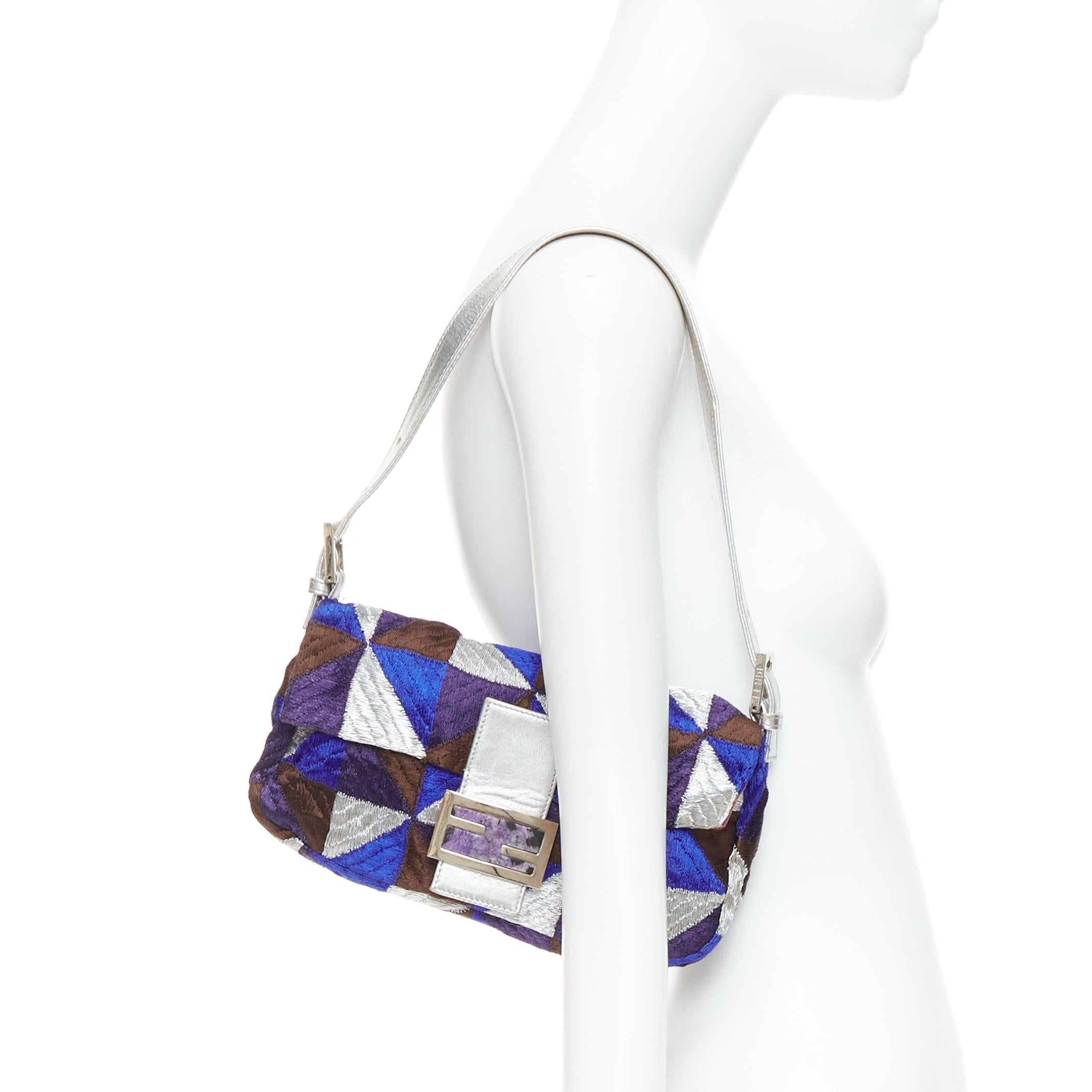 FENDI Vintage Mamma Baguette blue silver purple fabric shoulder bag
Reference: TGAS/E00710
Brand: Fendi
Model: Mamma Baguette
Material: Fabric, Leather
Color: Purple, Silver
Pattern: Geometric
Closure: Magnet
Lining: Purple Fabric
Extra Details: