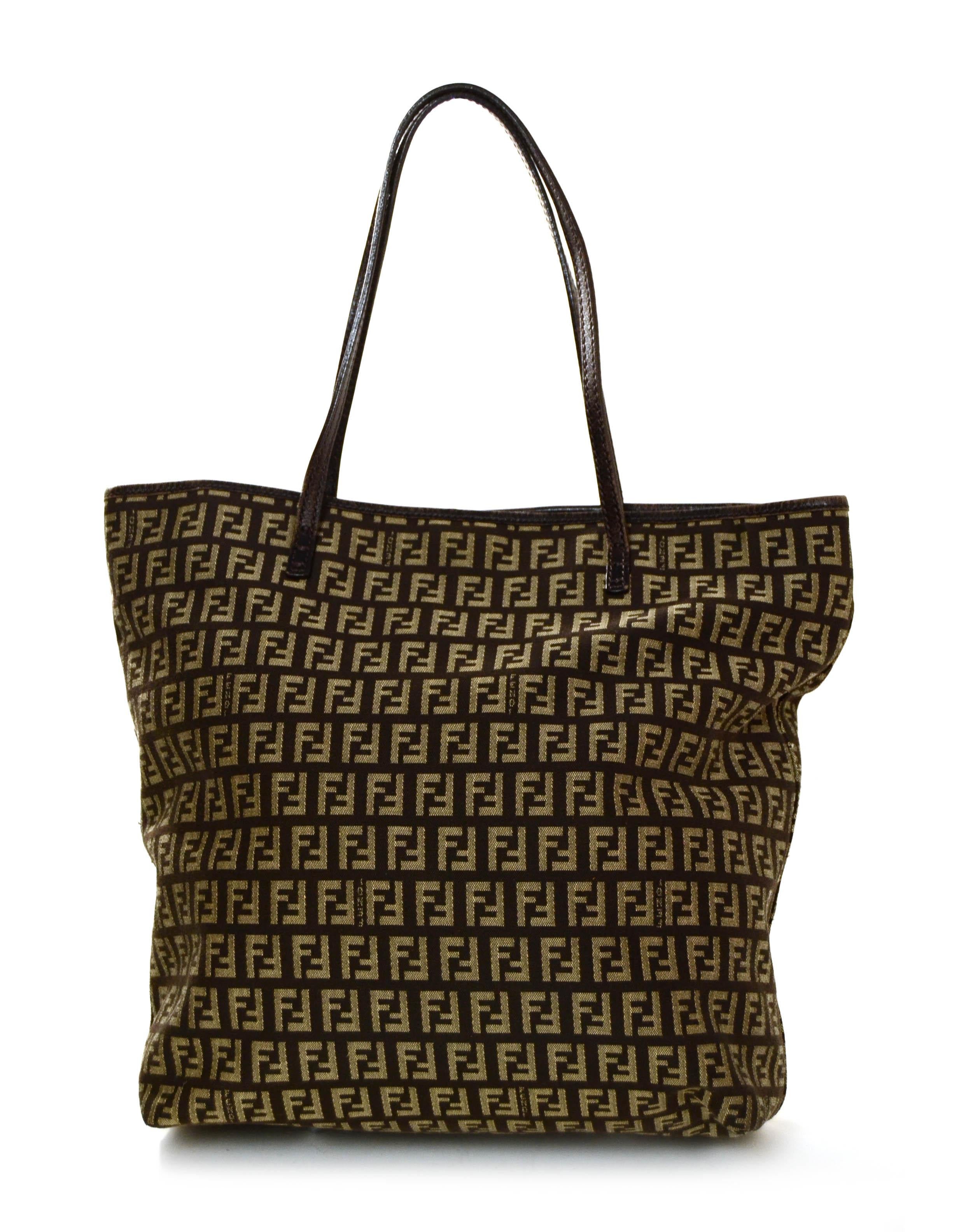 Fendi Mini Monogram Brown/Beige Tote Bag

Made In: Italy
Year of Production: Vintage
Color: Brown monogram
Hardware: Silvertone
Materials: Canvas
Lining: Nylon
Closure/Opening: Magnetic snap
Interior Pockets: Two small side by side
Exterior