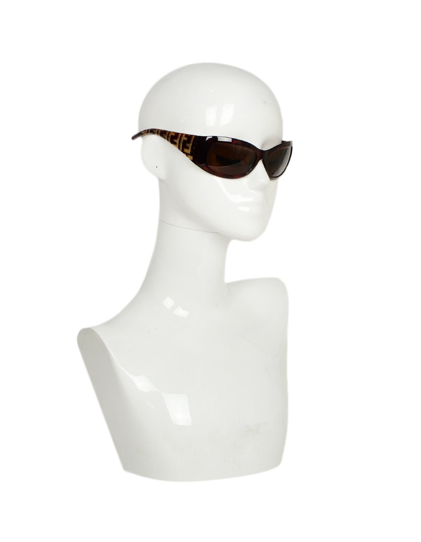 Fendi Vintage Monogram Sunglasses

Made In: Italy
Color: Brown
Hardware: Silvertone hardware
Materials: Acetate
Overall Condition: Very good pre-owned condition, with minor scratches to corner lenses
Includes: Case
Measurements: 
Length Across