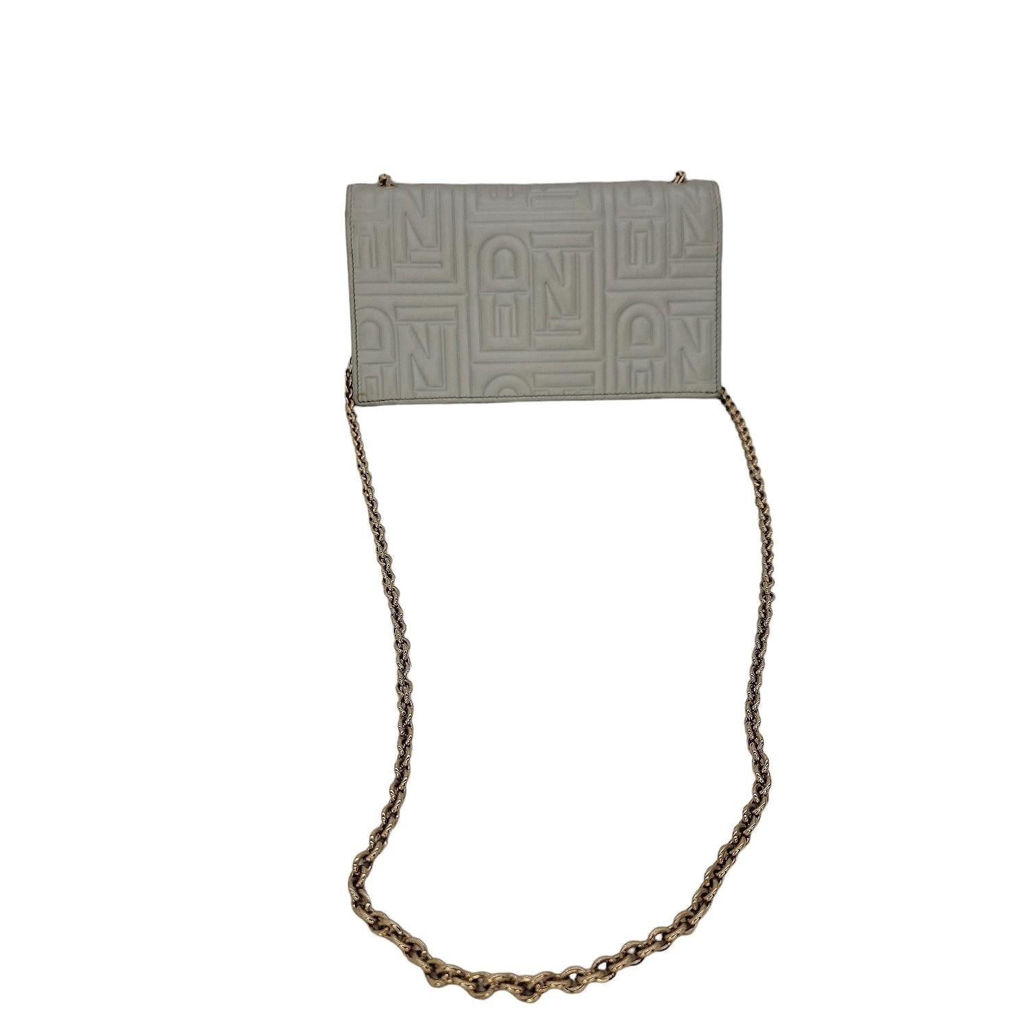 Fendi Metallic Nappa Logo Embossed Long Wallet On Chain in Silver. This chic wallet is crafted of silver embossed leather with the Fendi FF monogram. The bag features a waist-length gold chain link shoulder strap and a frontal flap and light brass