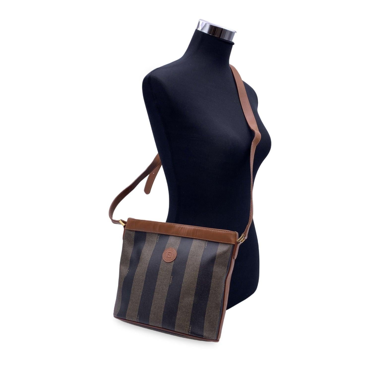 Gorgeous vintage FENDI shoulder bag crafted in striped Pequin canvas with tan leather trim and shoulder strap. Upper zipper closure. Black fabric lining with 1 side zip pocket inside. 'Fendi - Made in Italy' tag inside. 1 side zip pocket inside.