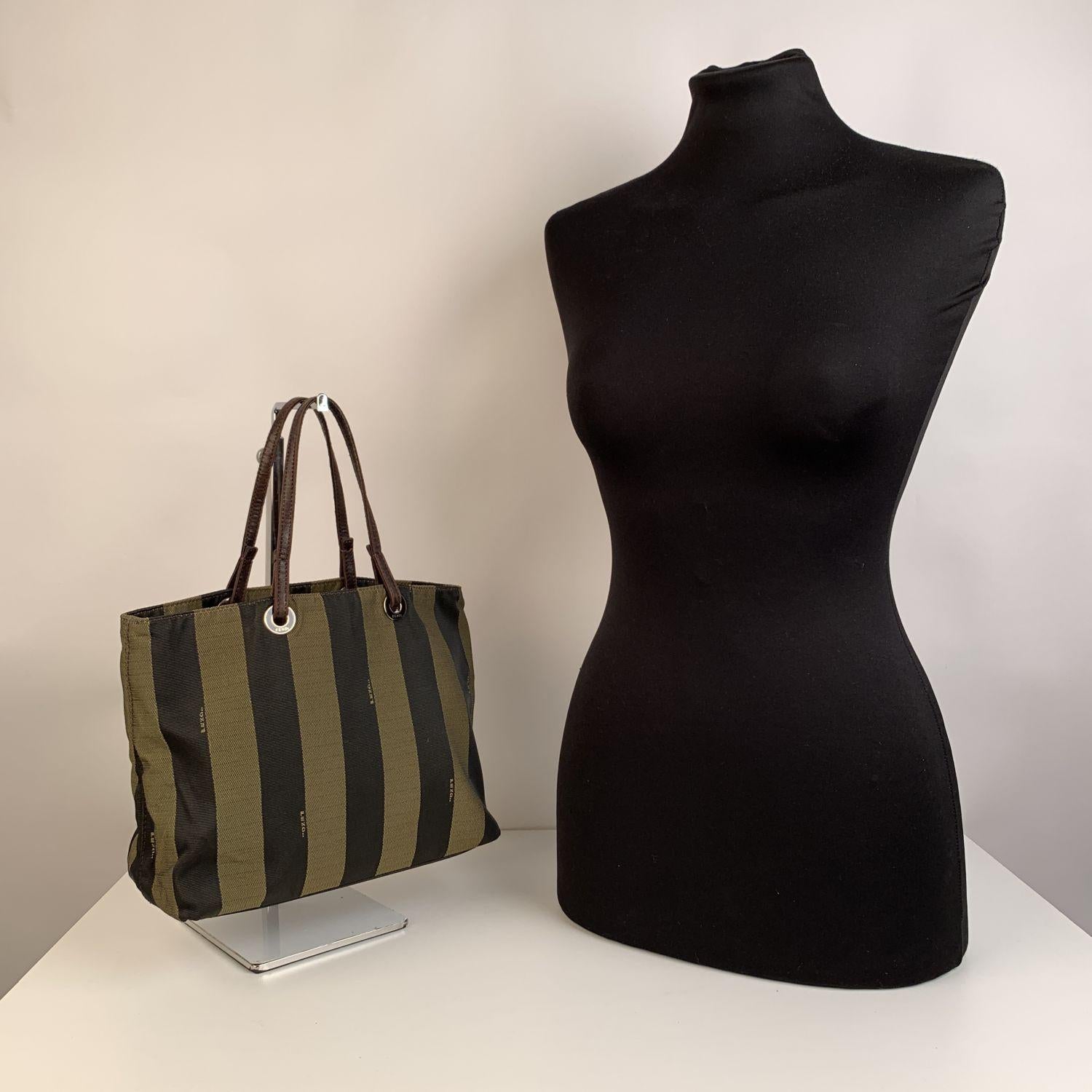 We offer Certificate of Authenticity provided by Entrupy for this item at no further cost.

Beautiful Fendi Pequin small tote bag. Crafted of striped pequin canvas with brown leather handles. The bag features an open top,2 main compartments with 1