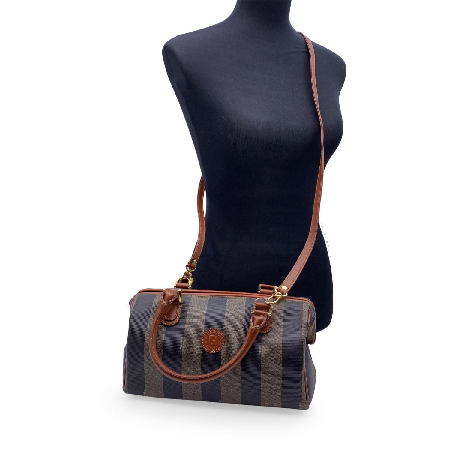 Fendi Vintage Pequin Striped Vinyl Canvas small boston bag. Striped Pequin canvas with brown leather trim and handles. Upper zipper closure. Black canvas lining. Removable shoulder strap. 'Fendi s.a.s. Roma - Made in Italy' embossed