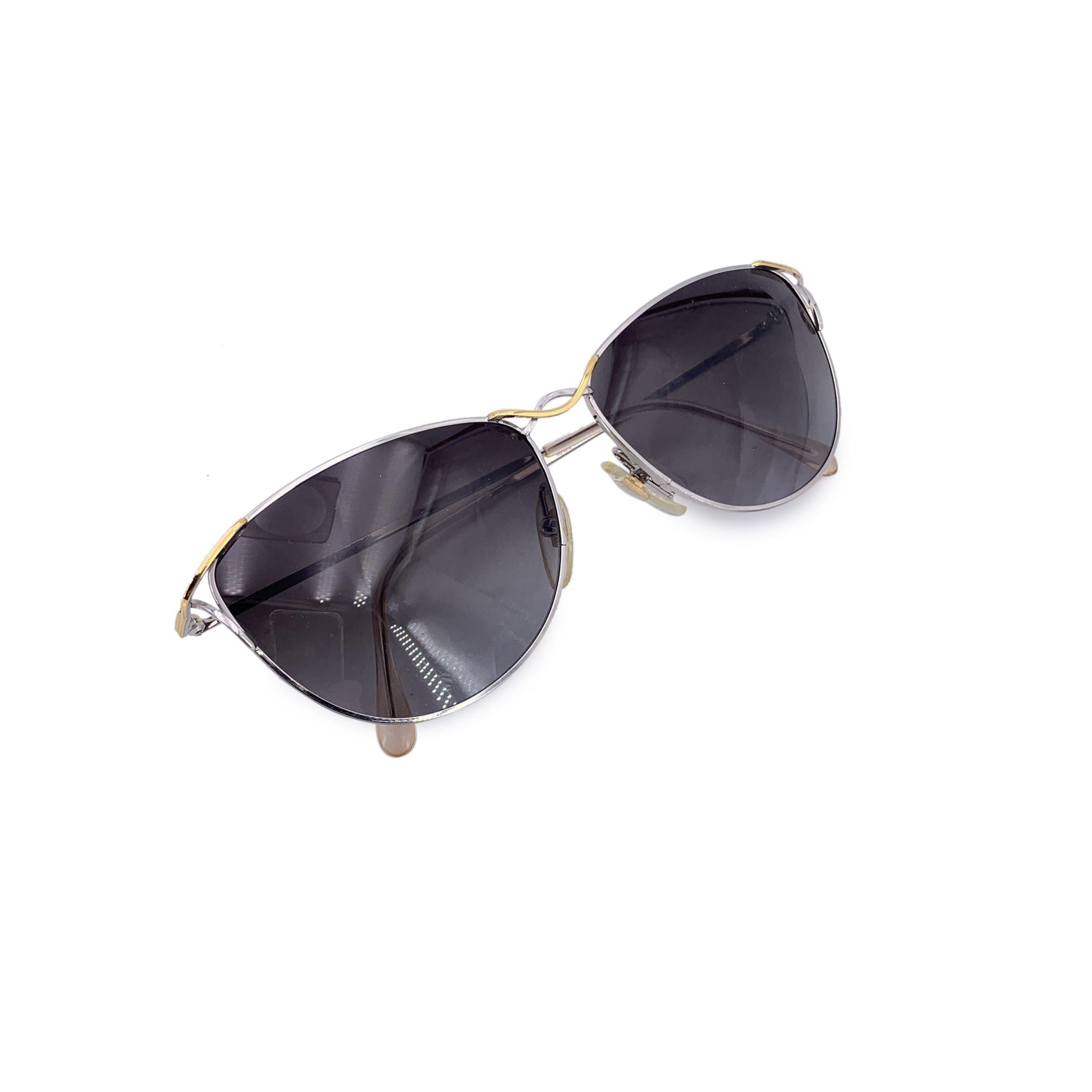 Step into the bold elegance of the 1980s with these Fendi vintage silver sunglasses. A striking example of the era's glamorous style, their silver plastic frame glistens with understated luxury, while the cat-eye shape adds a touch of vintage flair