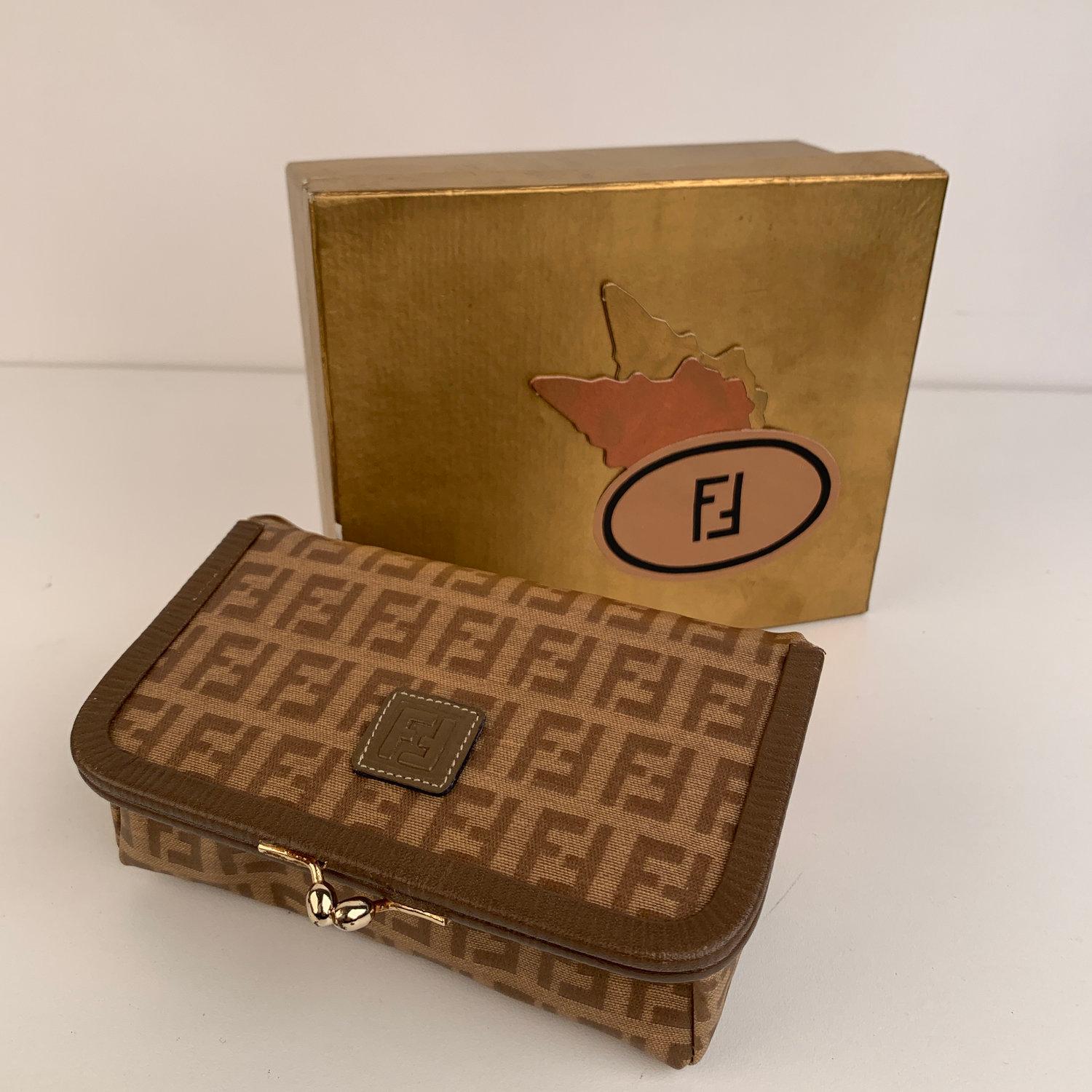 Beautiful vintage Fendi cosmetic case, crafted in tan FF monograms vinyl canvas with genuine leather trim. Kiss lock closure and mirror inside. It can be used also as a travel jewelry case. FF - FENDI logo patch on the lid. 'Fendi s.a.s Roma - made