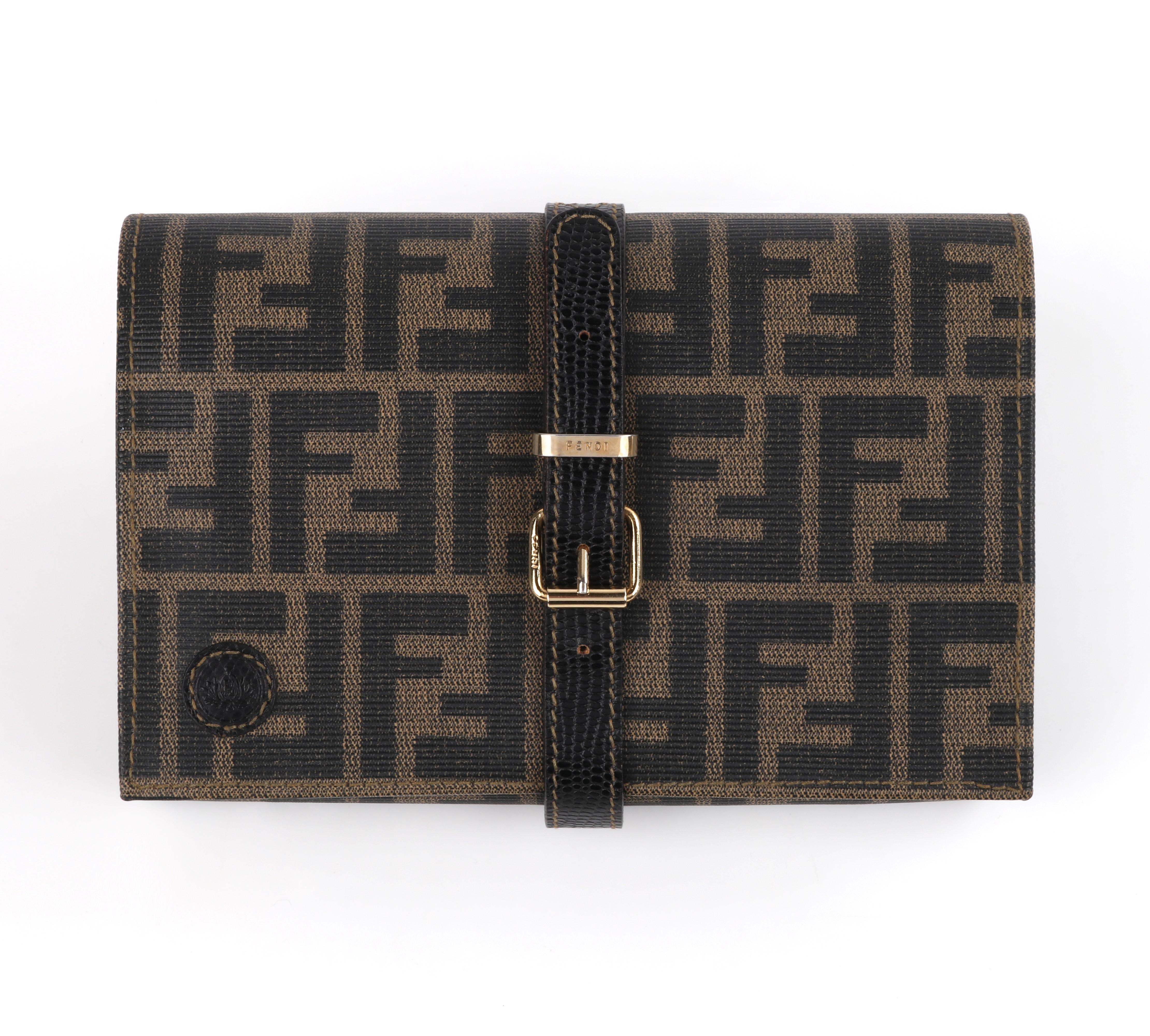 FENDI Vintage Zucca Buckle Strap Clutch Handbag Detachable Pochette Pouch Bag Jewelry Travel Roll
 
Brand/Manufacturer: Fendi
Style: Clutch/Jewelry roll
Color(s): Shades of taupe, brown, and black; gold (hardware)
Lined: No
Unmarked Fabric Content