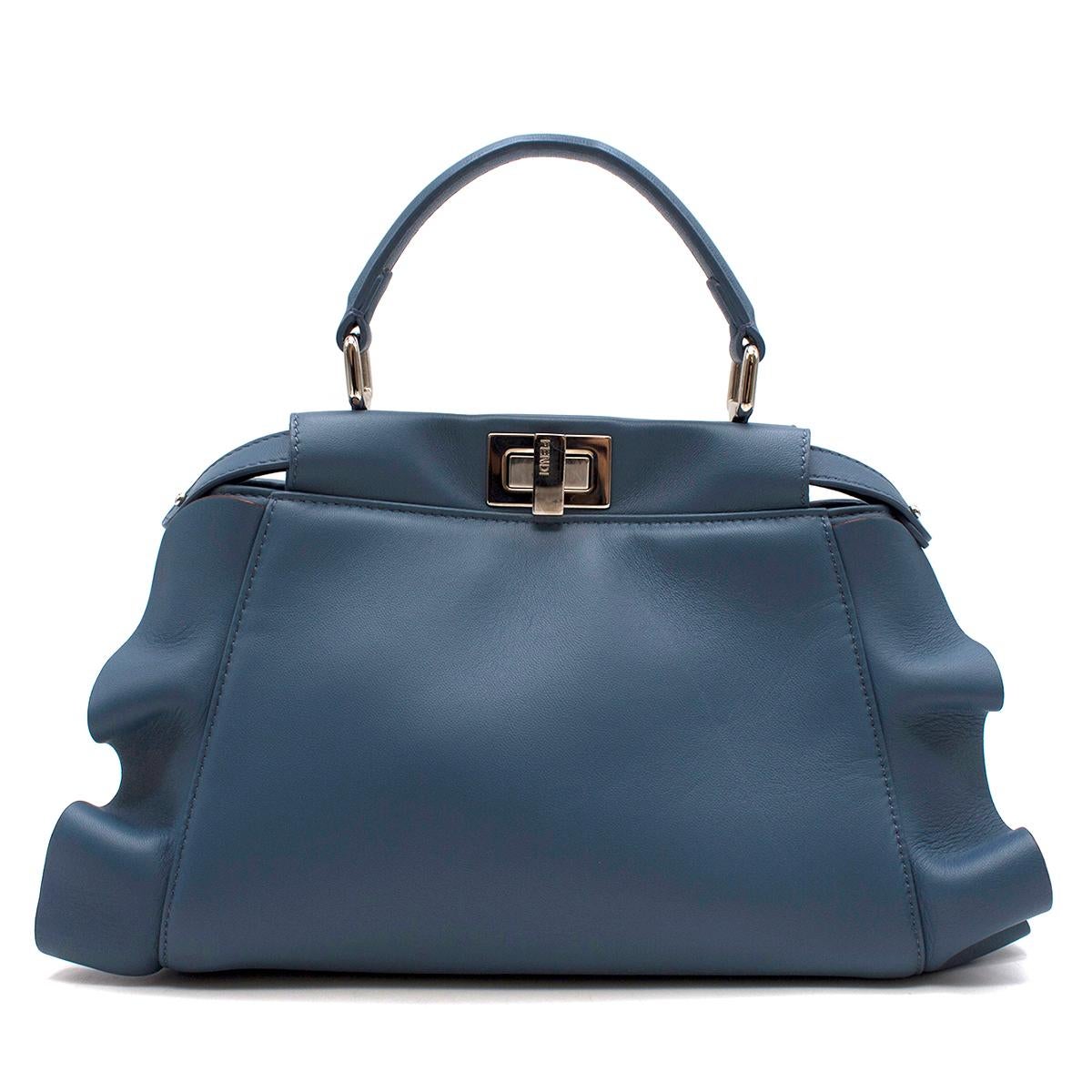 Fendi Wave Peekaboo Micro Bag

-Limited edition -

-Blue leather peekaboo bag
-Blue 'wave' ruffles on either side
-Silver tone hardware
-Two twist clasps embossed with 'Fendi'
-One top handle with detachable shoulder strap
-Two main interior pockets