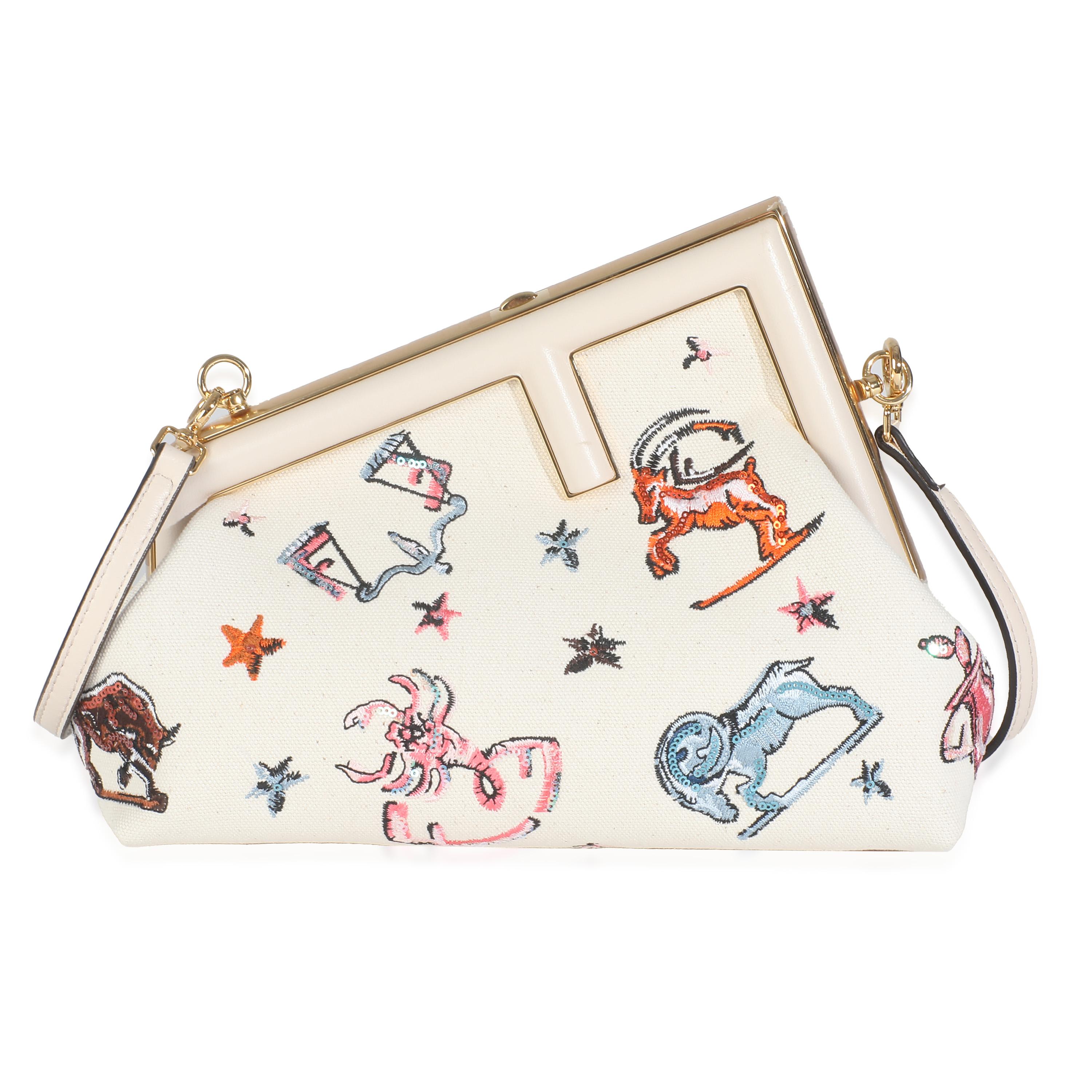 Listing Title: Fendi White Astrology Embroidered Canvas First Small Bag
SKU: Z146340
Condition: Pre-owned 
Handbag Condition: Excellent
Condition Comments: Item is in excellent condition and displays light signs of wear.  Light scuffing along