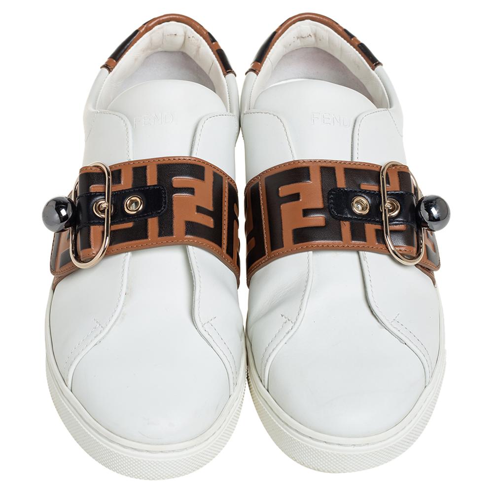 Flaunt your love for fashion by wearing these amazing slip-on sneakers from Fendi. They are expertly crafted from leather and feature the signature Zucca pattern detailed on the straps on the vamps. They are endowed with comfortable leather-lined