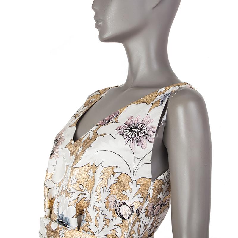 Fendi brocade godet dress in gold, off-white, light grey, lavender, and mauve polyester (5/%), cotton (27%), and silk (10%). With v neck and v back. Closes with hook and invisible zipper on the side. Lined in pink silk organza (100%). Comes with