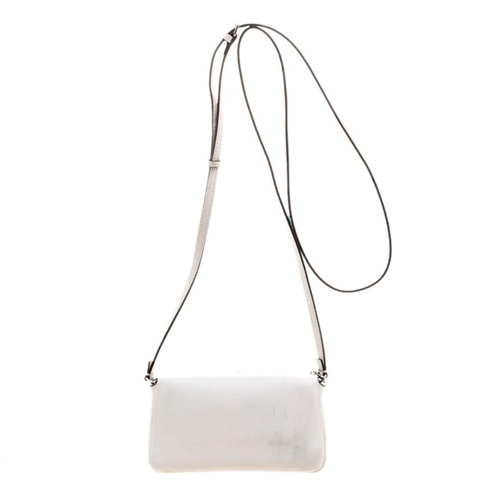 The Monster Baguette bag from Fendi comes with a unique twist. The front flap features embellishments along with the striking Forever lock in silver tone. Crafted from white leather, it has a suede lined interior sized to hold all your essentials.