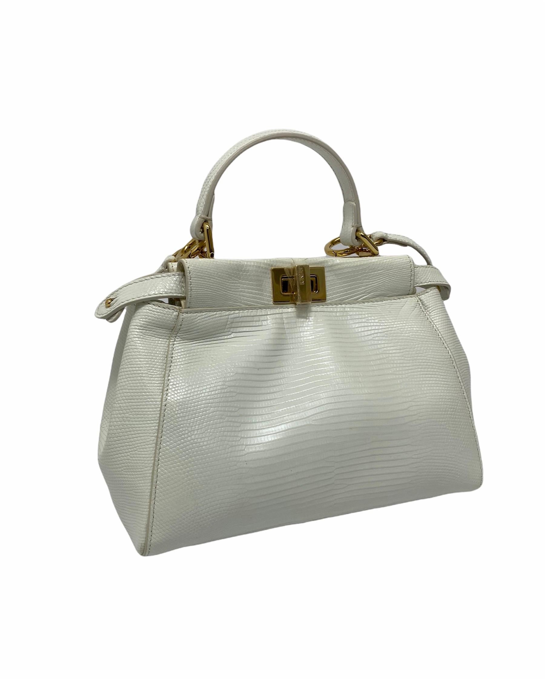 Fendi Peekaboo model bag made of leather of white reptile with golden hardware. Closure with hook, internally quite large and equipped with pockets. Equipped with leather handle and removable shoulder strap. The bag is in like new condition.