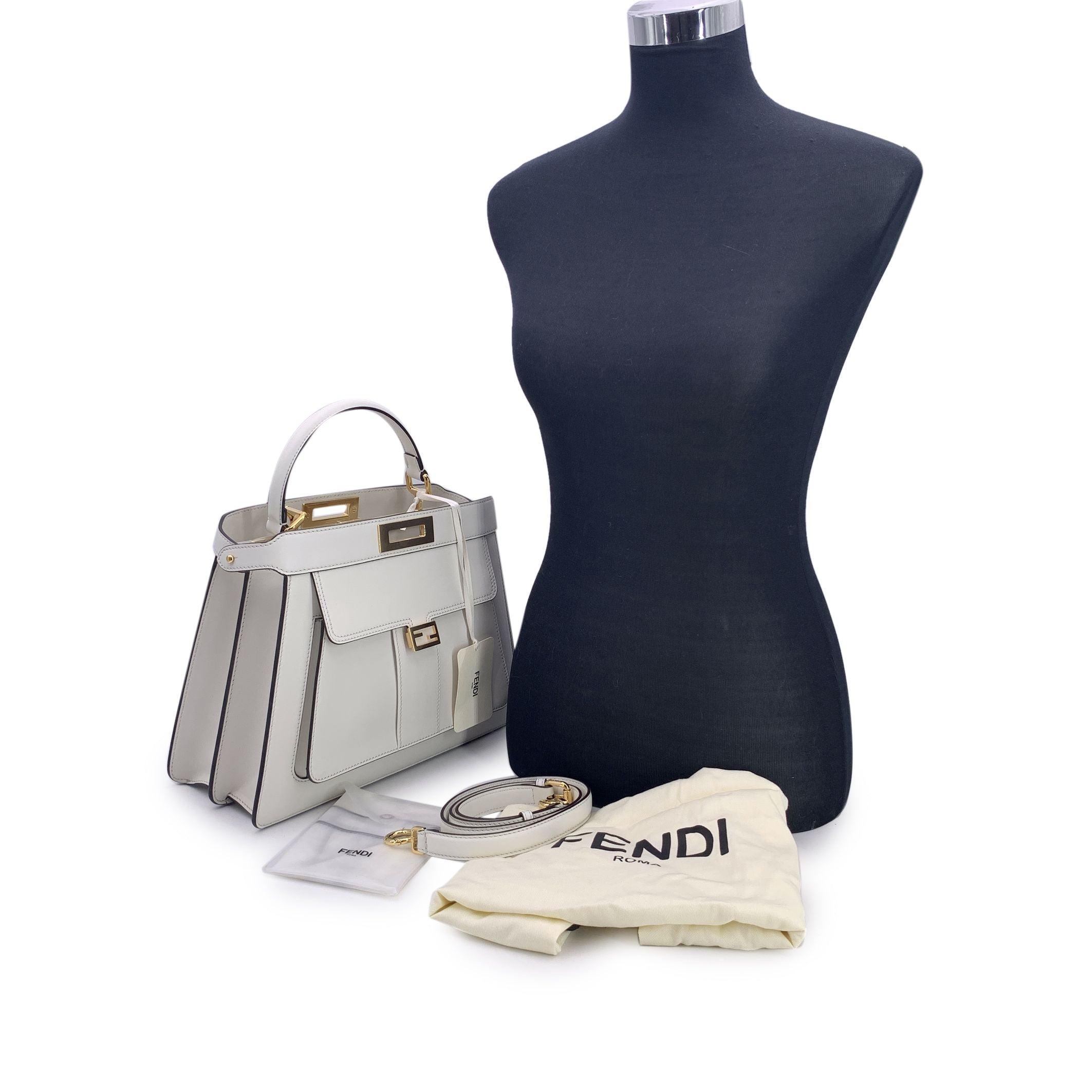 This beautiful Bag will come with a Certificate of Authenticity provided by Entrupy. The certificate will be provided at no further cost. A modern icon with roots in timeless Italian craftsmanship, this Fendi Selleria Peekaboo ISeeU bag in crisp