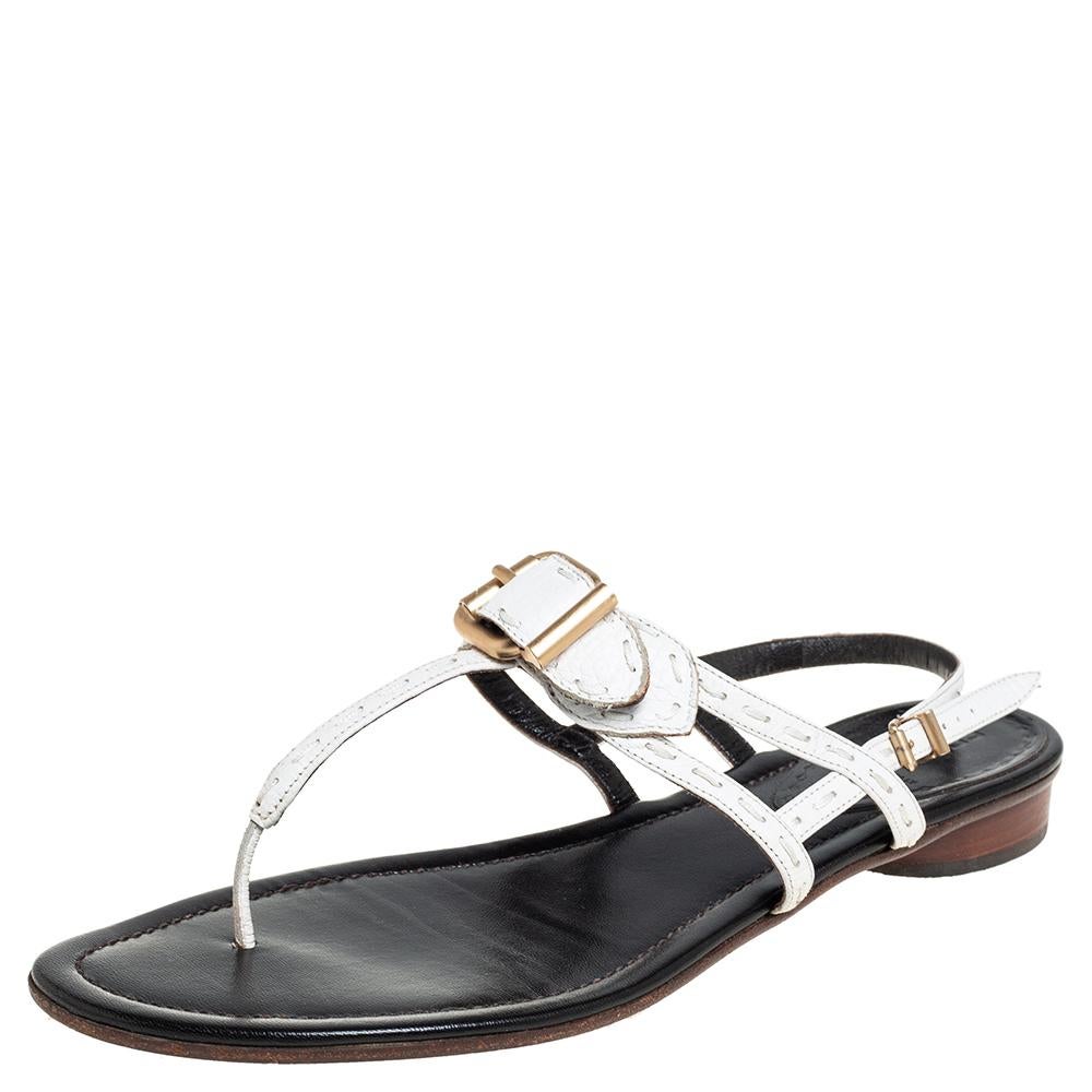 These sandals from the house of Fendi are lovely! They have been crafted from leather. The pair carries a T-strap silhouette and is accented with a gold-tone buckle on the front, ankle fastening, and the Selleria stitch details.

