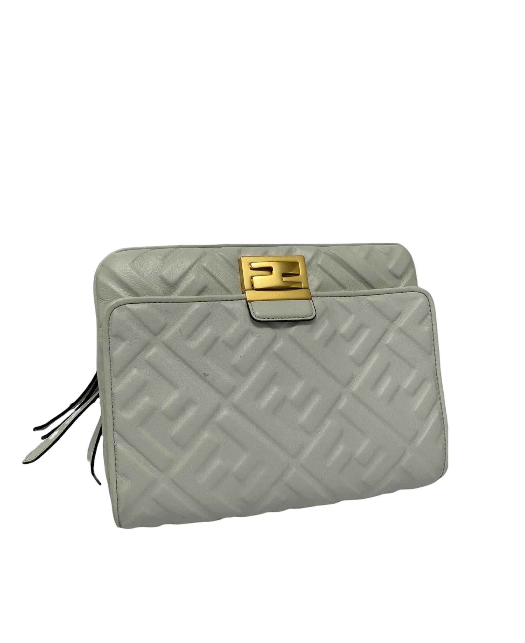 Upside Down belt bag by Fendi in white FF Logomania leather with golden hardware.  Features an Upside Down front flap with interlocking closure. The pouch carries a central opening with zip closure, with the interior lined with a black fabric.  In