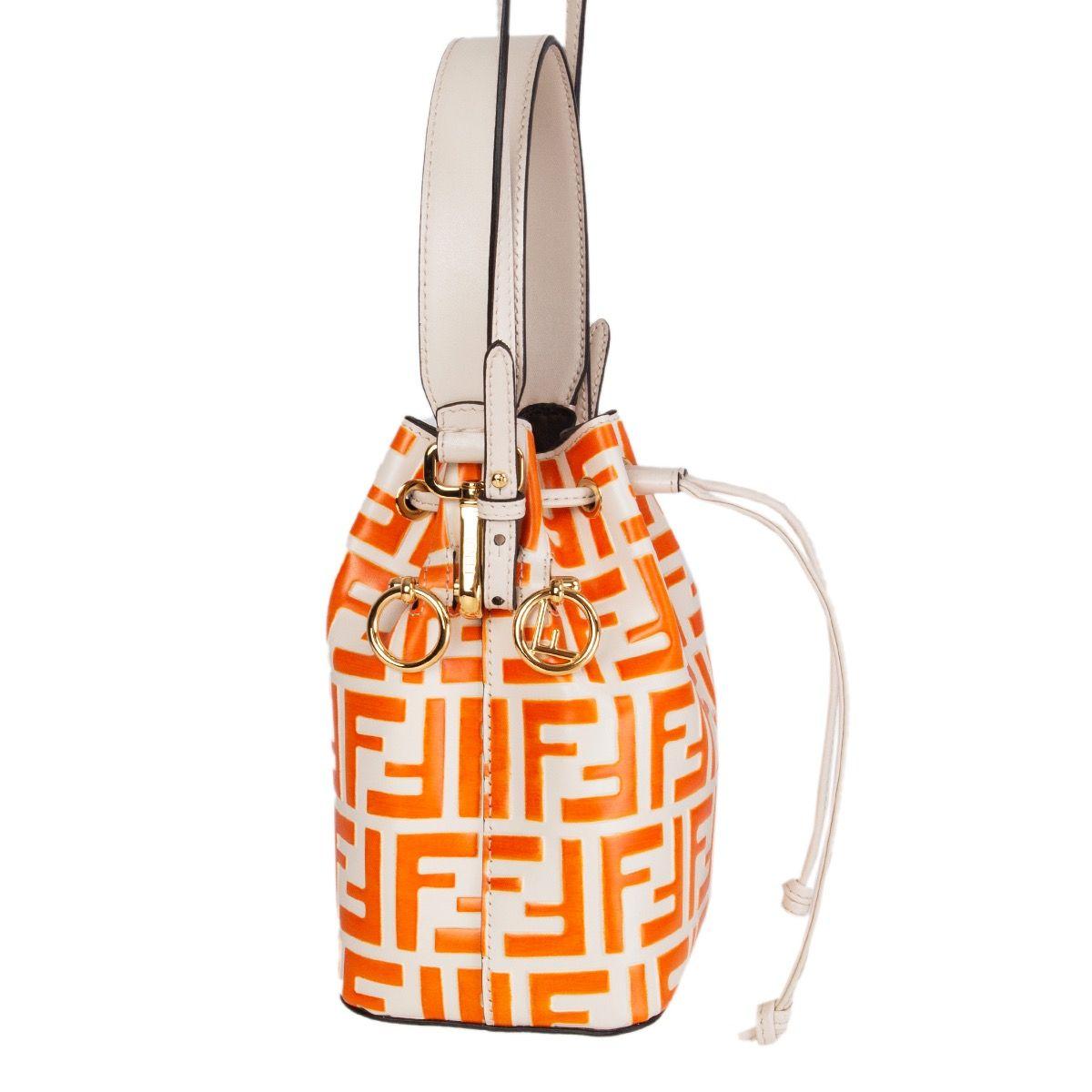 Fendi 'Mon Tresor' mini bucket bag in orange and off-white calfskin FF logo embossed finish, featuring a detachable top-handle, an adjustable shoulder strap, gold-tone hardware and a drawstring fastening. Lined dark taupe alcantara. Has been carried