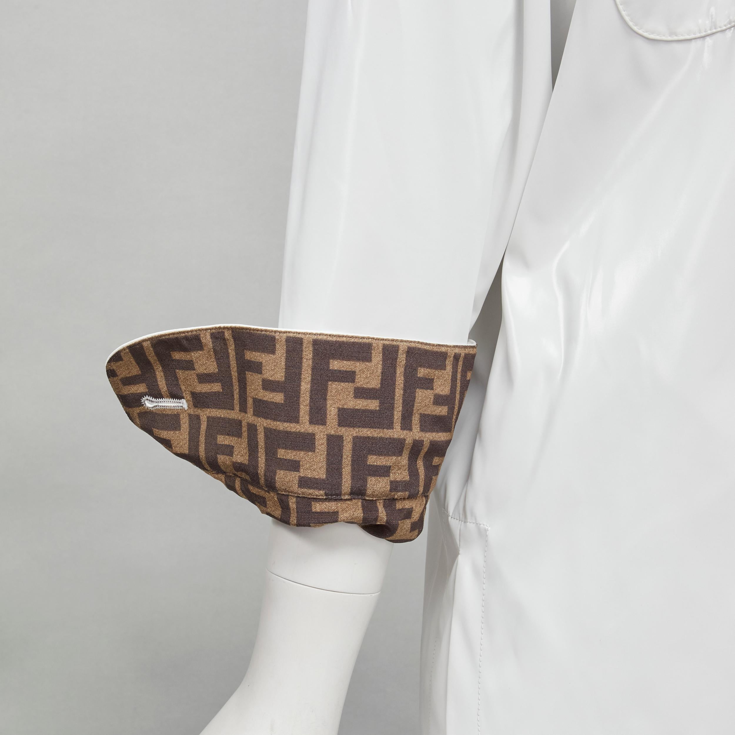FENDI white polyester brown FF Zucca monogram lined overshirt jacket IT36 XS
Brand: Fendi
Extra Detail: Shiny polyester outer with FF Zucca lining. Curved front hem. Large tortoise resin button. Dual patch breast pocket.

CONDITION:
Condition: Very
