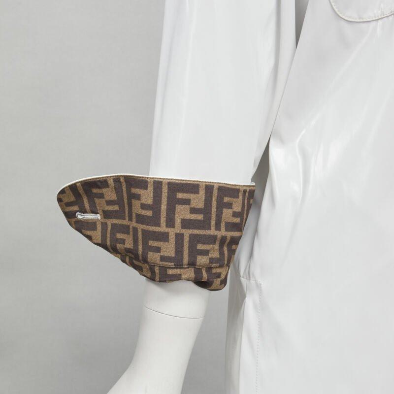 FENDI white sheen polyester brown FF Zucca monogram lined overshirt IT36 XS
Reference: KNLM/A00054
Brand: Fendi
Material: Polyester
Color: White, Brown
Pattern: Solid
Closure: Button
Extra Details: Shiny polyester outer with FF Zucca lining. Curved