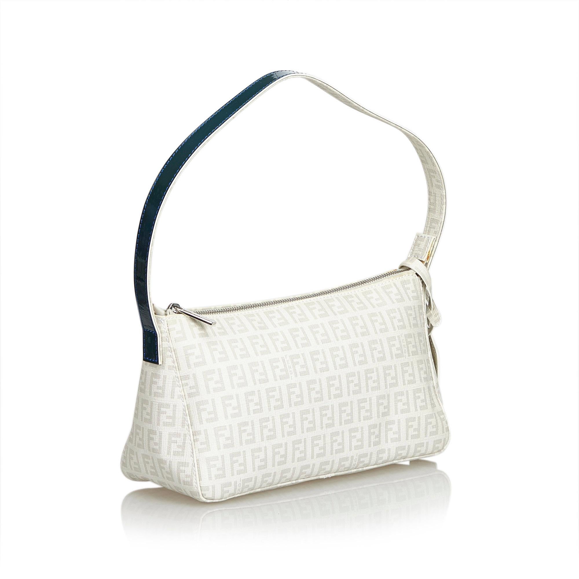 This shoulder bag features a canvas body, flat leather strap, top zip closure, and interior slip pocket. It carries as B+ condition rating.

Inclusions: 
This item does not come with inclusions.

Dimensions:
Length: 15.00 cm
Width: 26.00 cm
Depth: