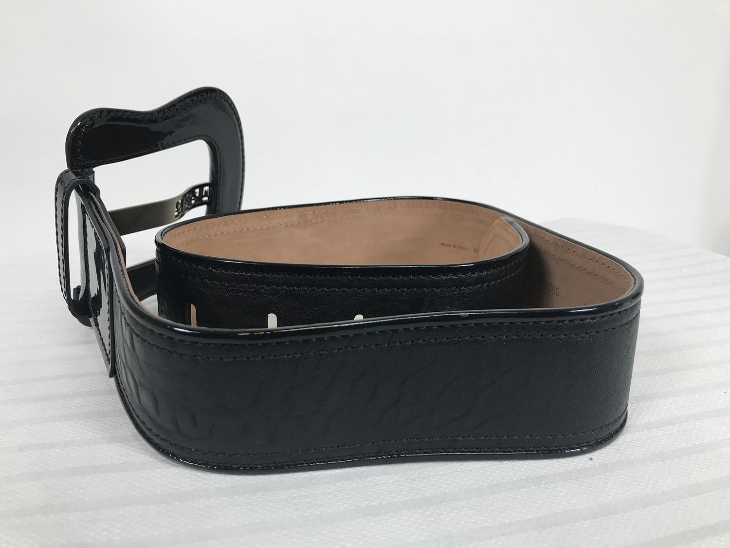 Fendi wide black patent & black leather, logo belt 34. Extra large black patent leather buckle with black stitching and burnished gold cut out logo prong. The belt is textured matte black leather with black patent welt trim and black stitching along