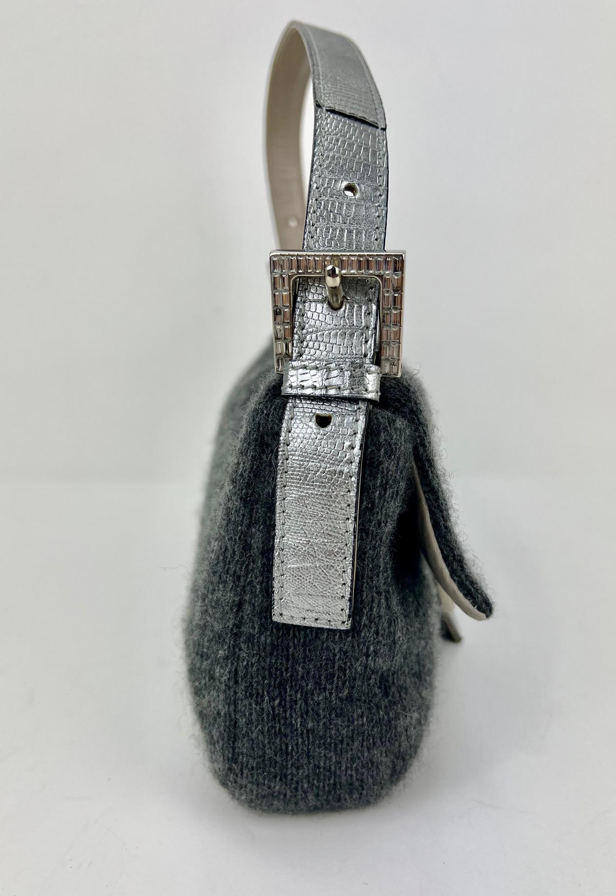 Pre-Owned  100% Authentic
FENDI Wool Crystal Grey Baguette Shoulder Bag
RATING: B...Very Good, well maintained,
shows minor signs of wear
MATERIAL: wool, leather, metallic
HANDLE:  adjustable leather strap, 1 side 
buckle is missing 6 crystals