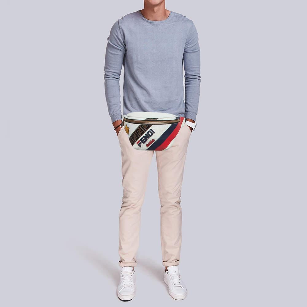 The Fendi x Fila belt bag is a stylish fusion of luxury and sportswear. Crafted from premium white leather it features Filas iconic multicolor logo pattern. The versatile design allows it to be worn as a belt or a crossbody bag adding a chic touch