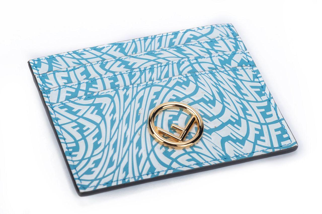 Fendi x Sarah Coleman card holder. The piece is crafted of leather and has a bulleye print with multiple Fs in the color light blue and white. It is brand new and comes with a box, dustcover and tag.