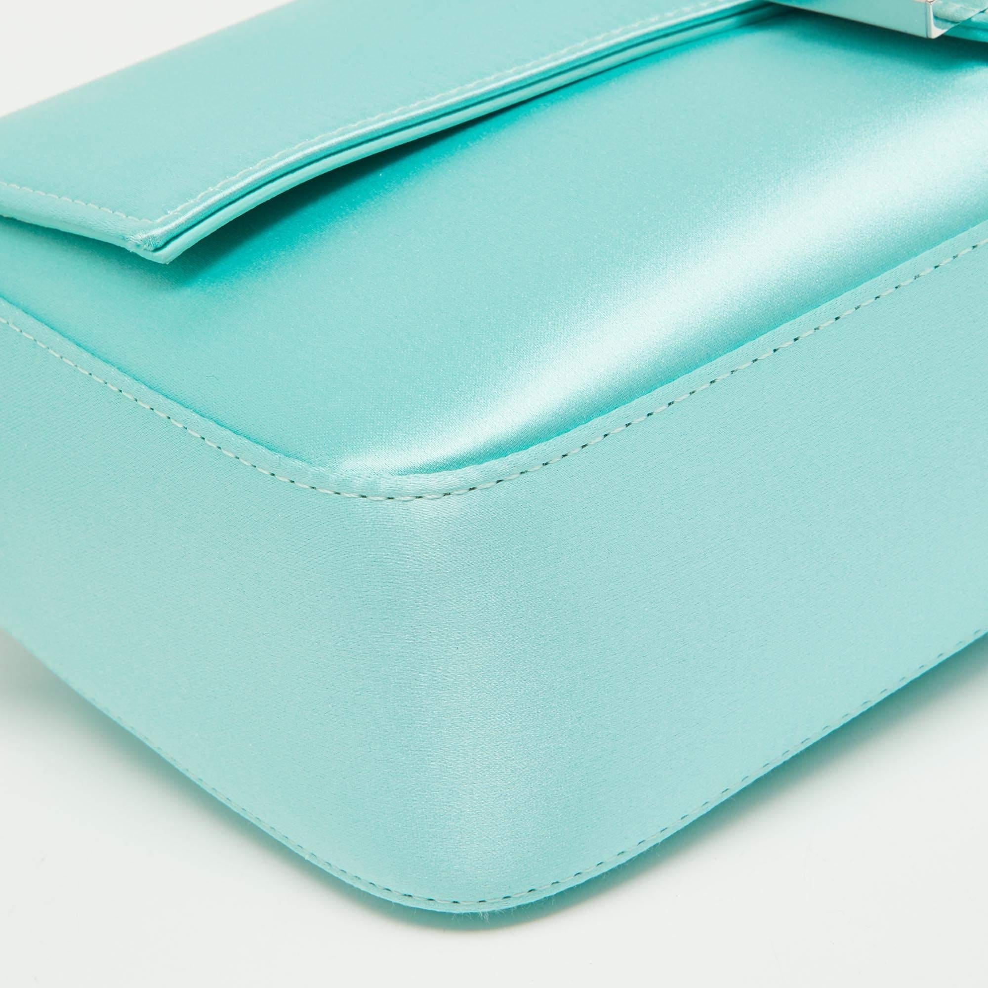 The Fendi x Tiffany & Co. Baguette Flap Bag exudes luxury with its collaboration of iconic brands. Crafted in sumptuous Tiffany Blue satin, it features a classic Baguette silhouette with Fendi's signature FF motif. The bag seamlessly blends timeless
