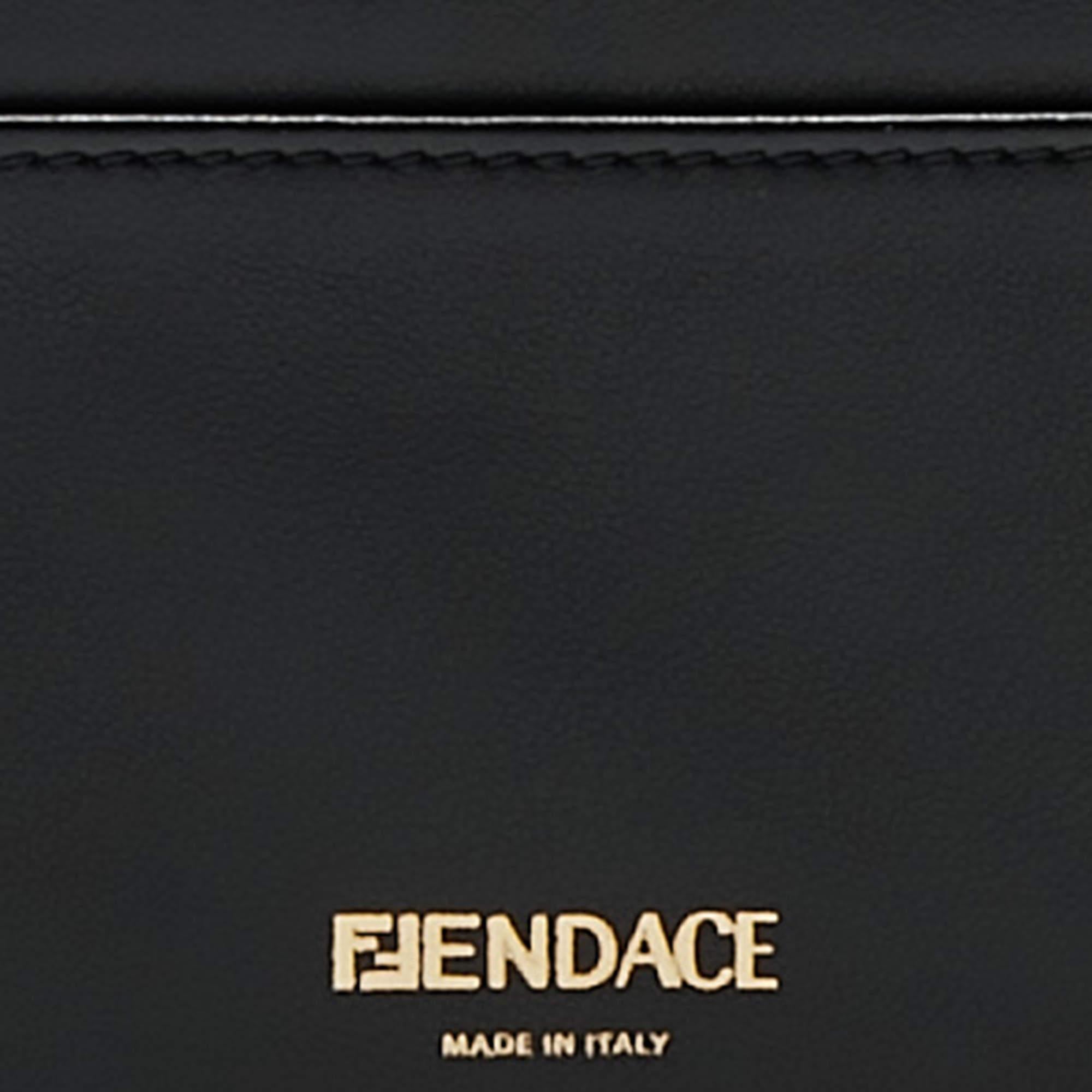 This luxurious Fendi x Versace Fendace lanyard boasts exquisite black and gold leather craftsmanship, marrying Fendi's timeless elegance with Versace's opulent flair. It features sleek lines, a convenient lanyard, and ample card storage, embodying