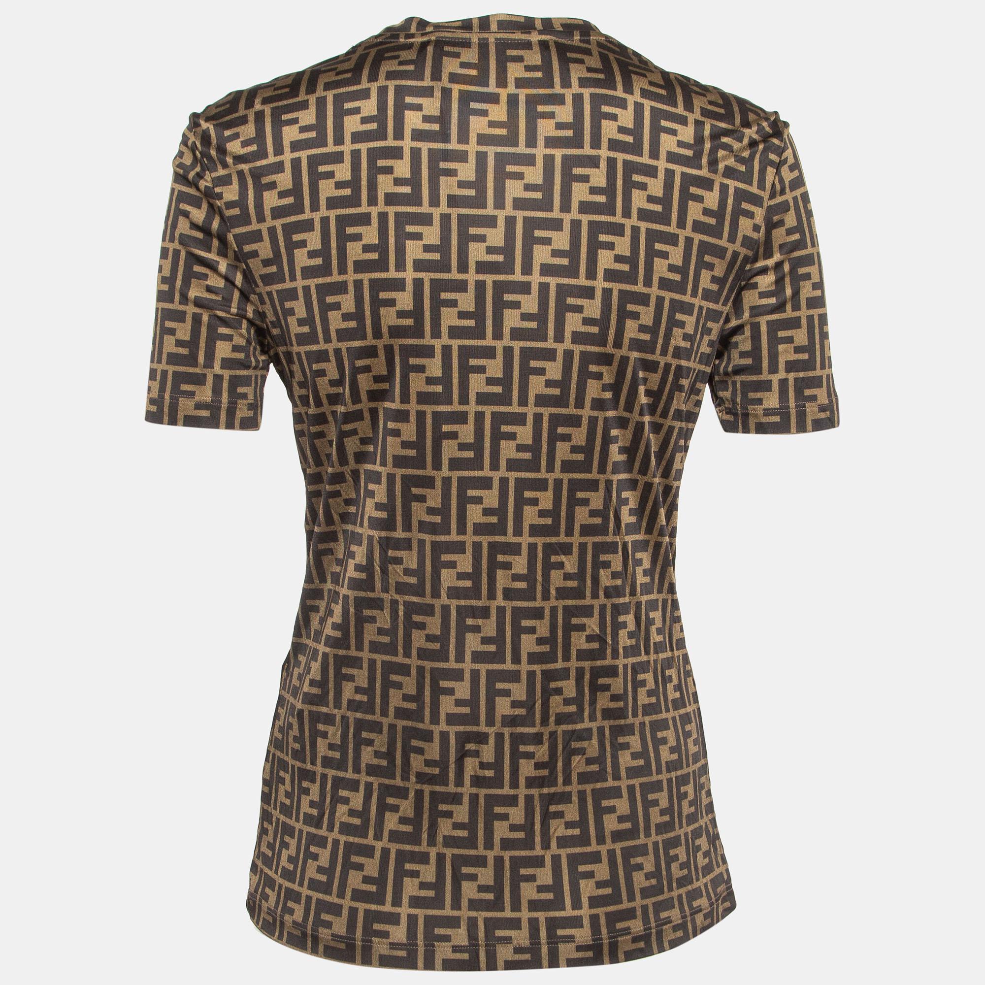 Immerse yourself in luxury with the Fendi x Versace t-shirt. Crafted with exquisite attention to detail, this opulent garment features a rich brown monogram pattern accented by sparkling crystal embellishments, effortlessly blending style and