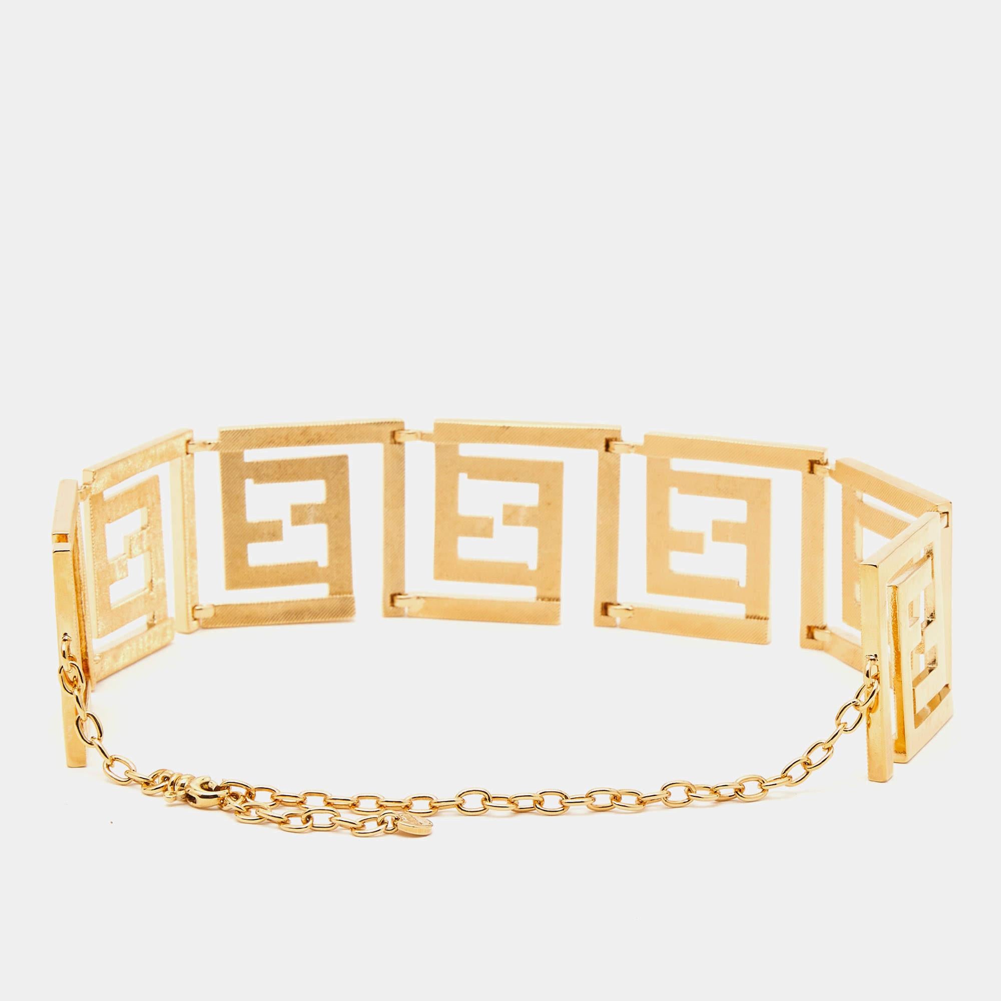 The Fendi x Versace Fendace necklace is a luxurious fashion accessory that exudes opulence and style. Crafted in exquisite gold-toned metal, it features a unique fusion of Fendi and Versace design elements, combining iconic logos and motifs to